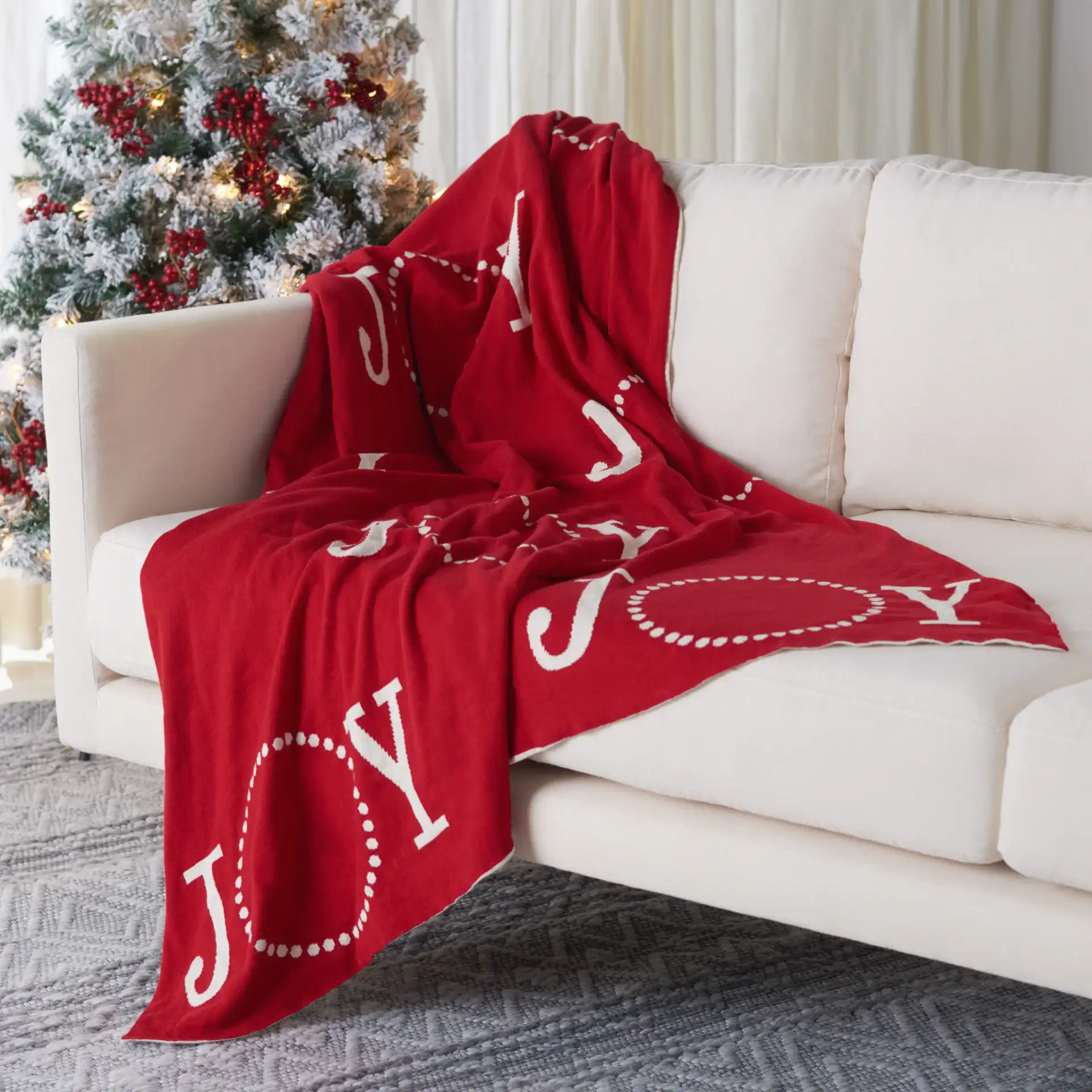Joy To The World Throw in Red / White in a styled room