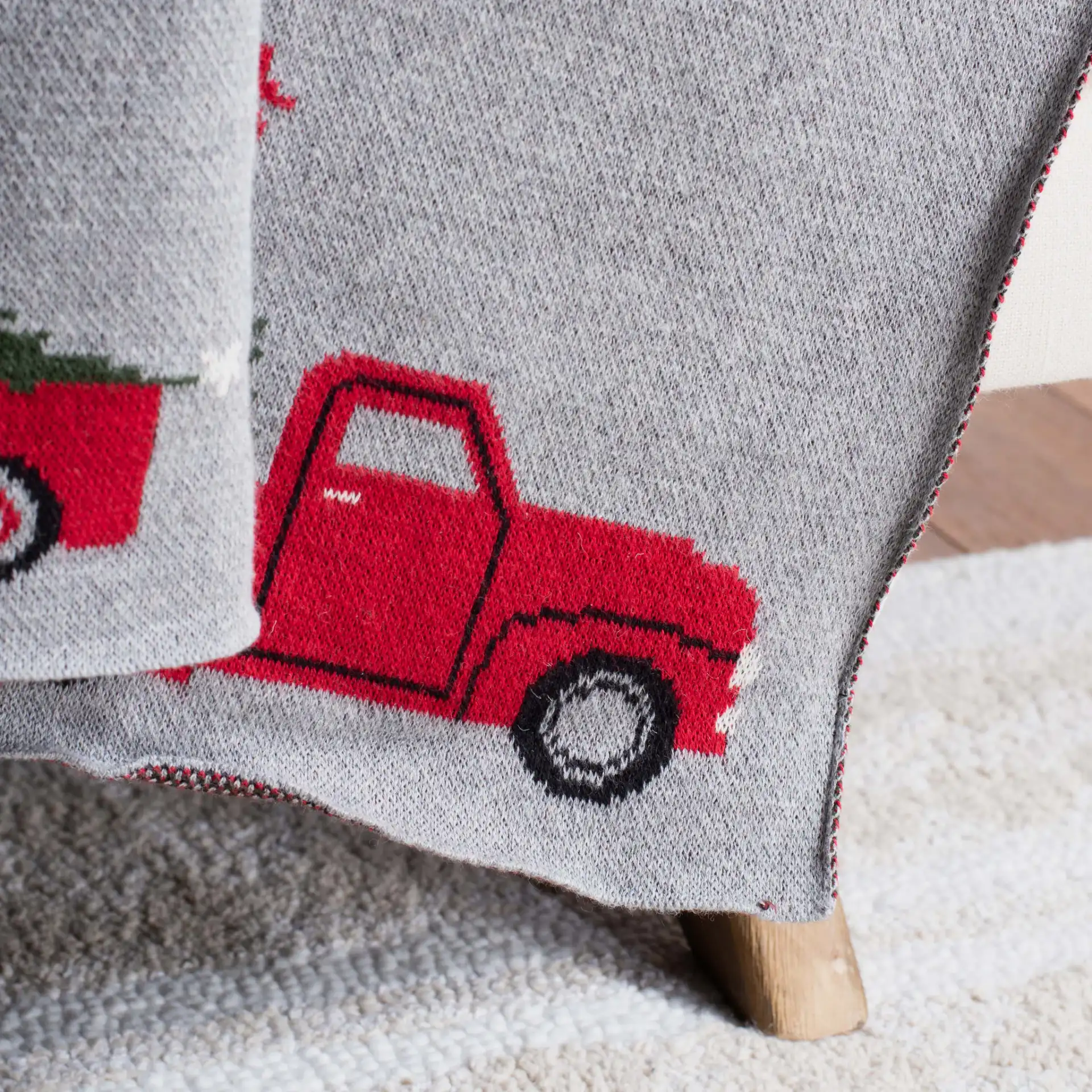 Dasher Throw in Gray / Red in a styled room