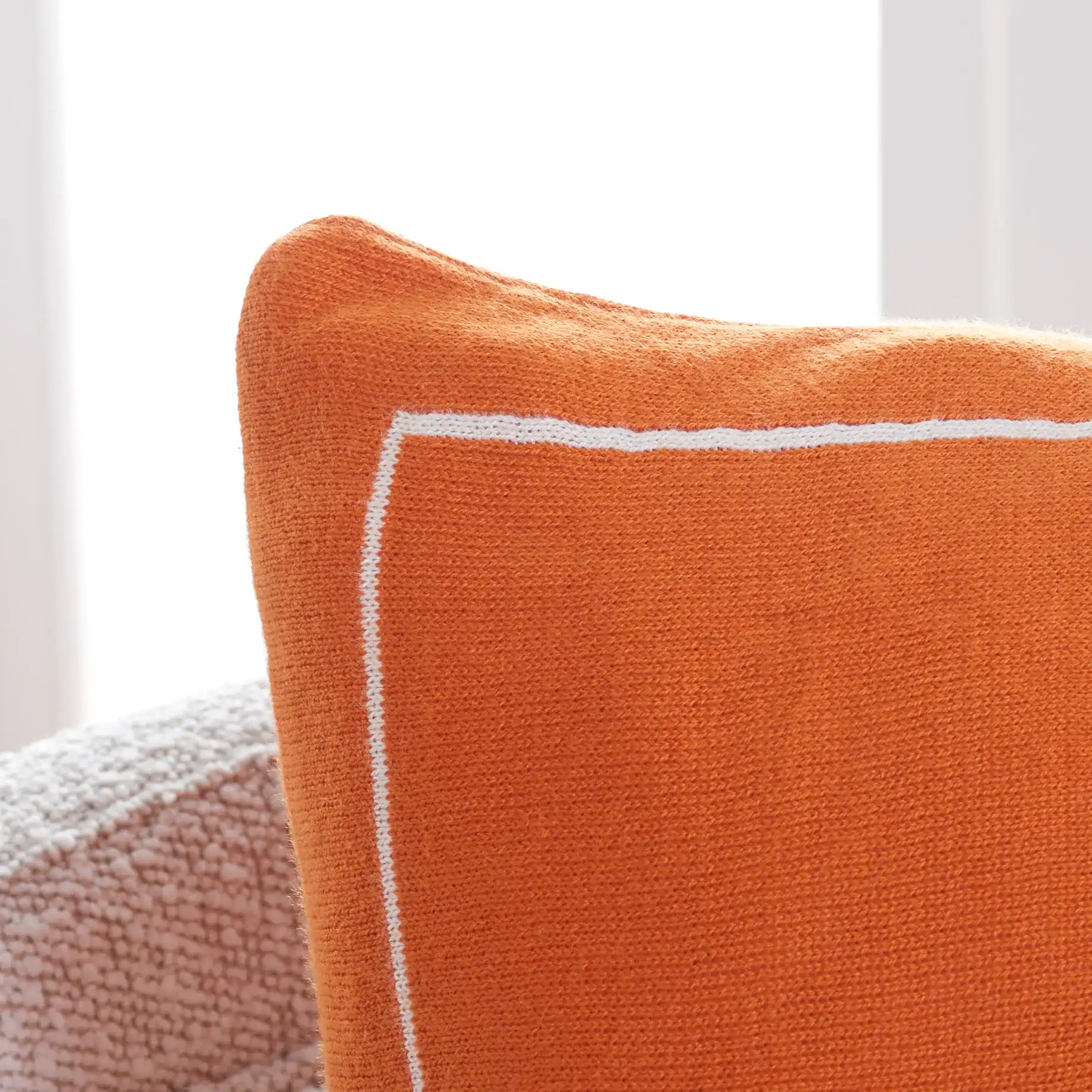Cuddle Weather Pillow in Orange / Natural in a styled room