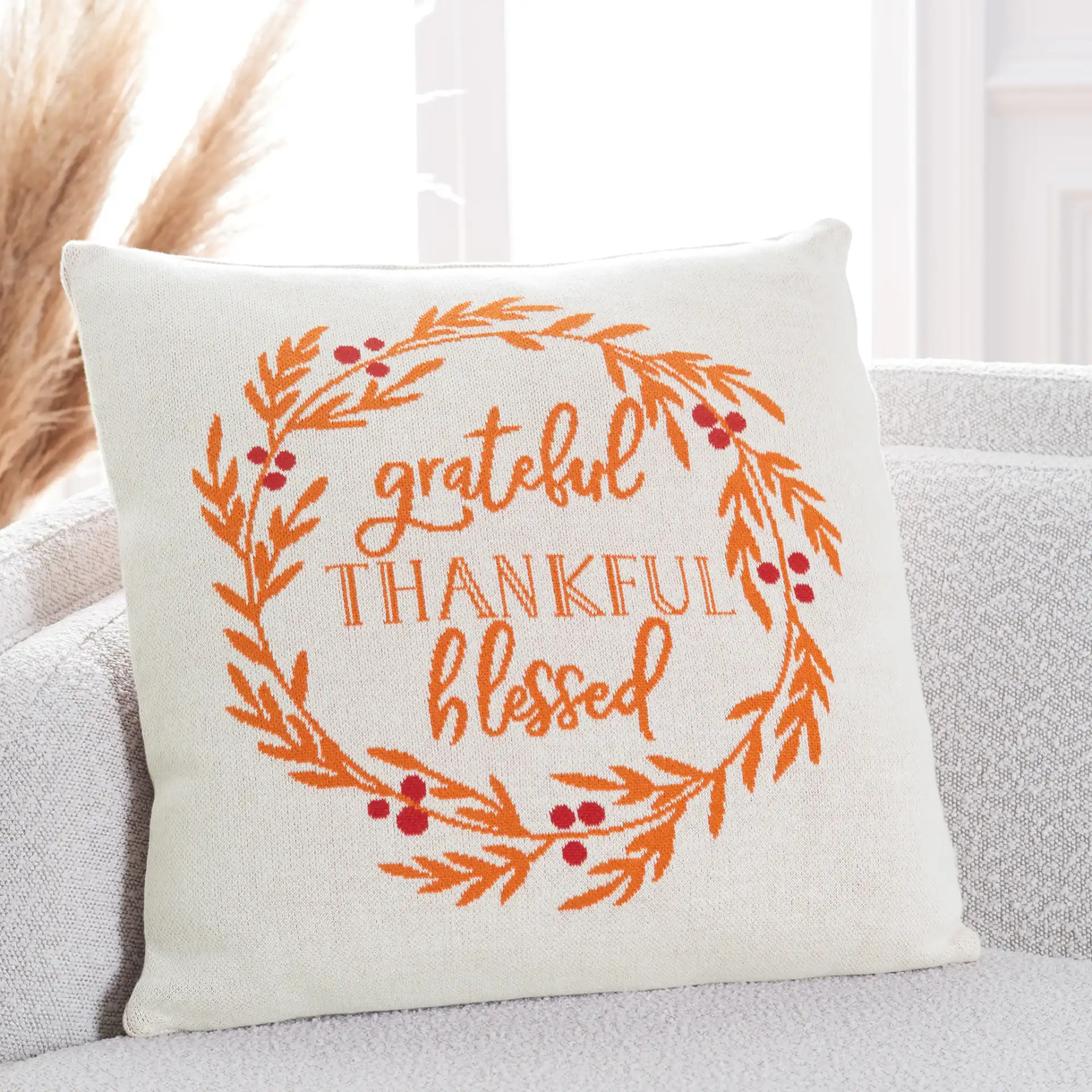 Grateful Blessed Pillow in Orange / Natural / Red in a styled room