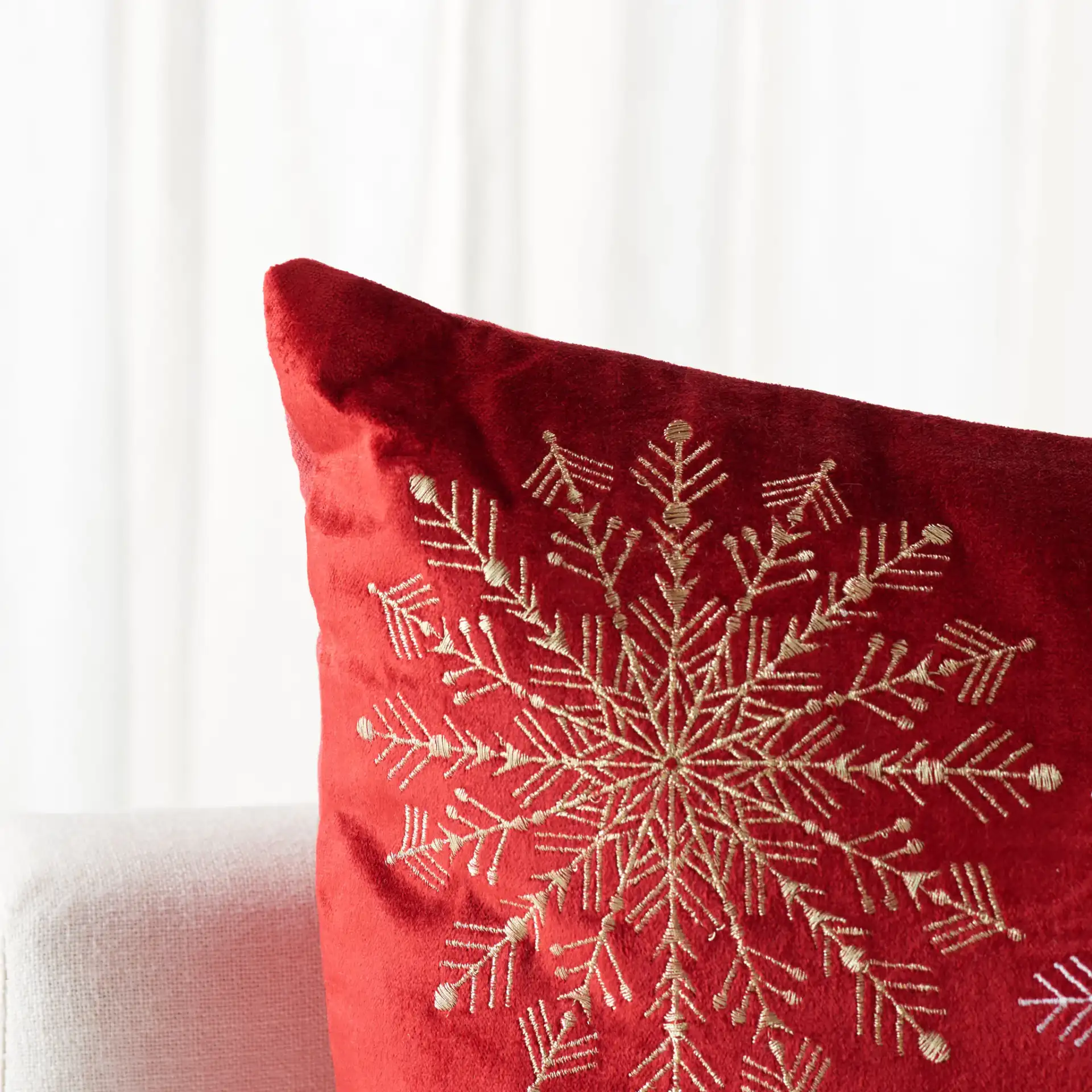Cinthia Snowflake Pillow in Red in a styled room