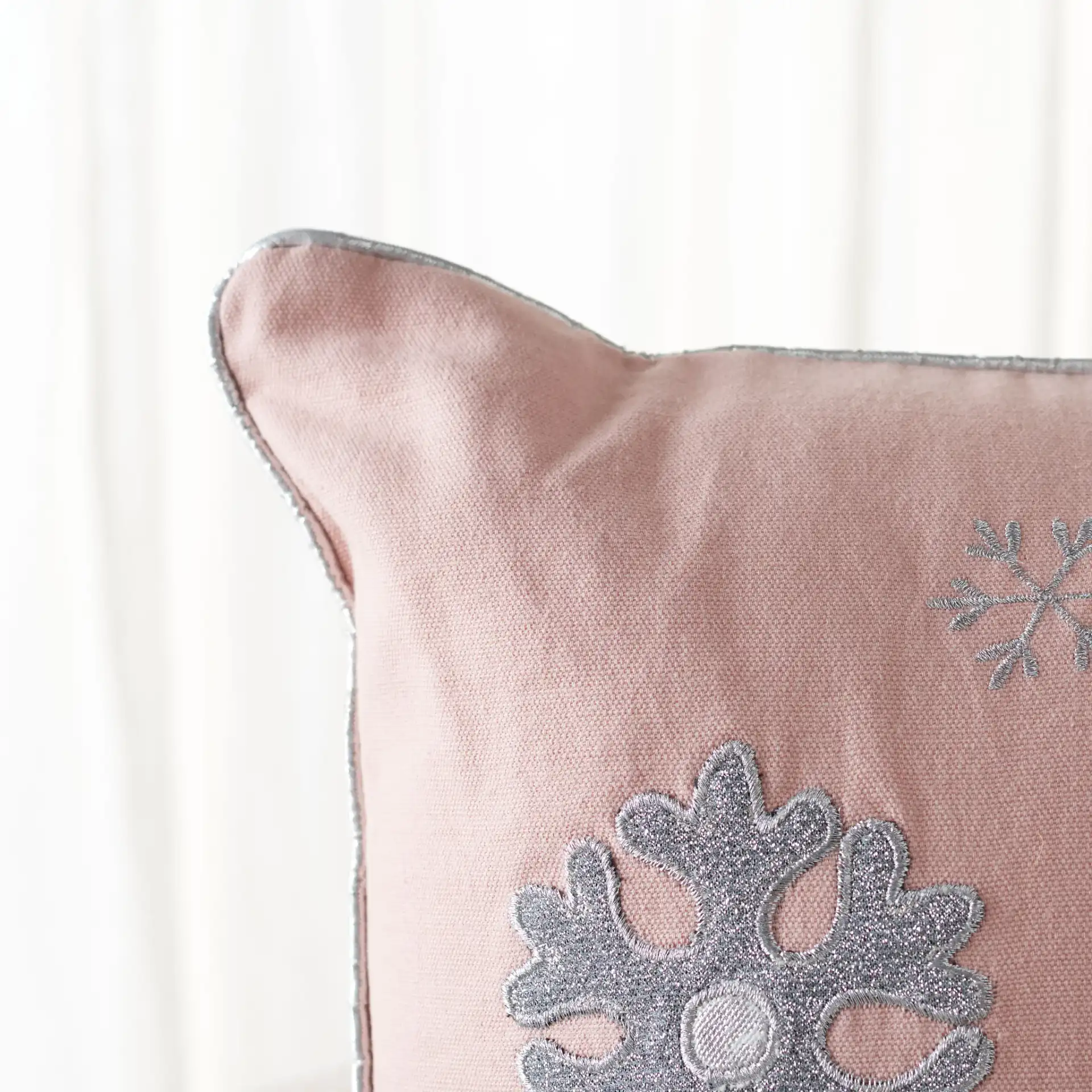 Sunderland Snowflake Pillow in Blush Pink in a styled room