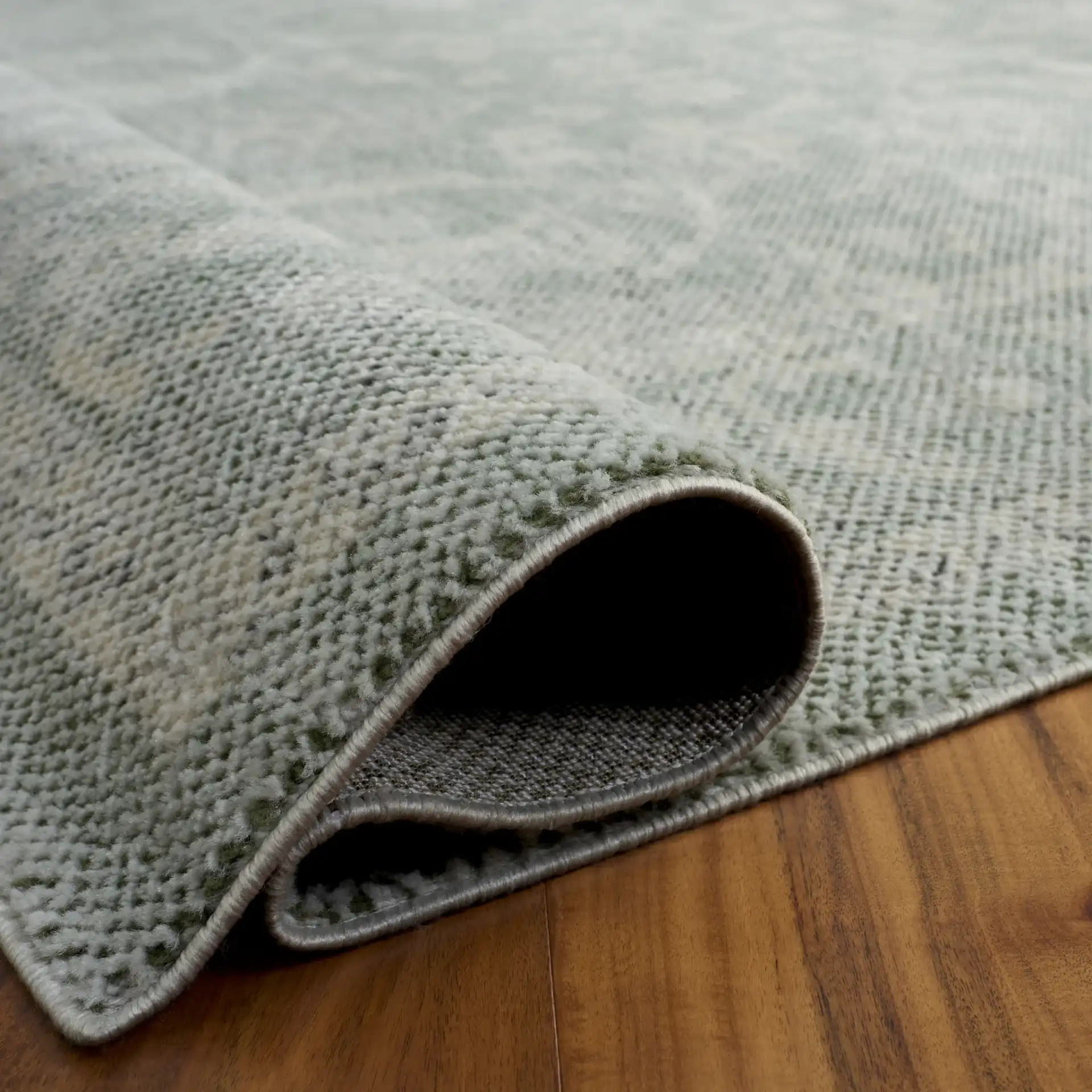 Harrison Bordered Floral Rug in Green / Ivory in a styled room