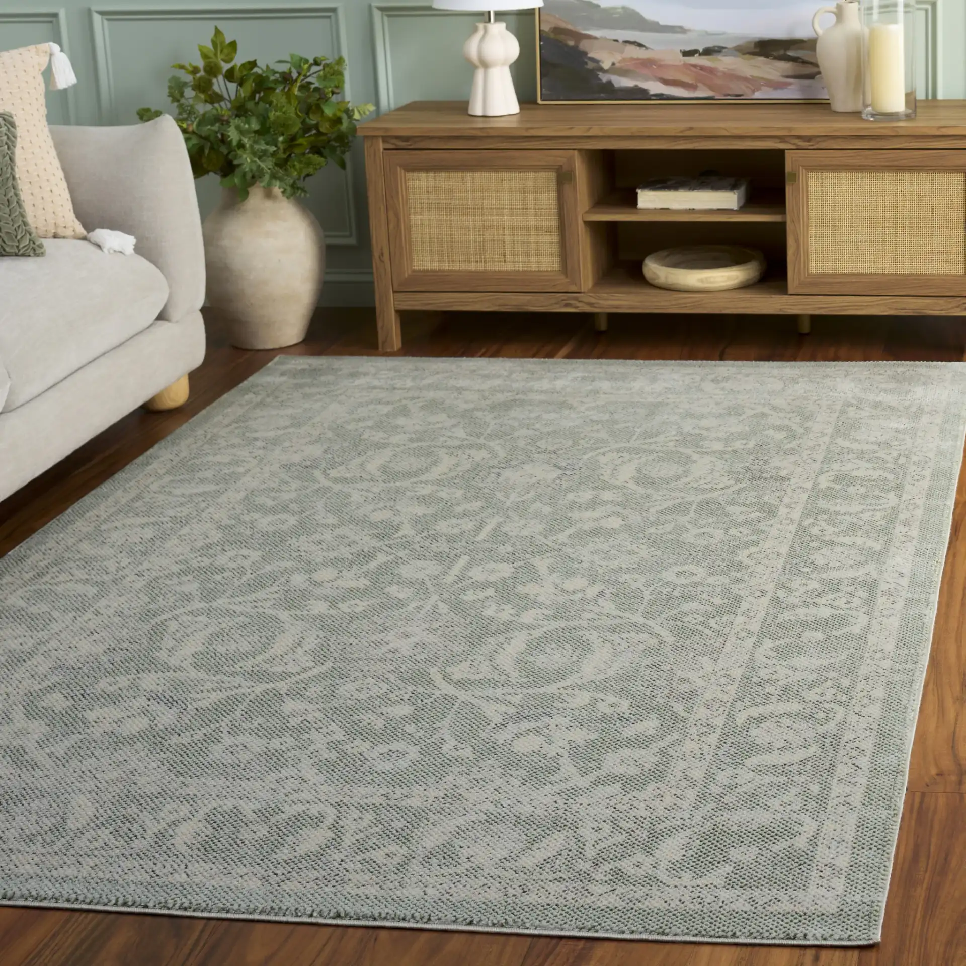 Harrison Bordered Floral Rug in Green / Ivory in a styled room