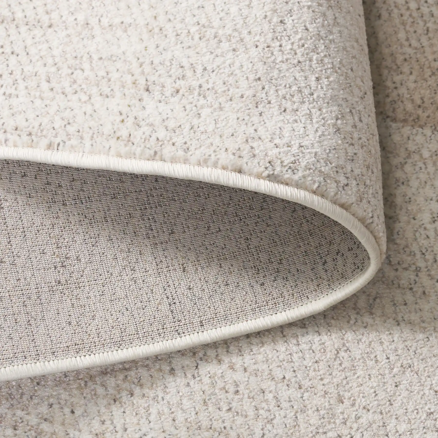 Herat Textured Solid Rug in Ivory / Beige in a styled room