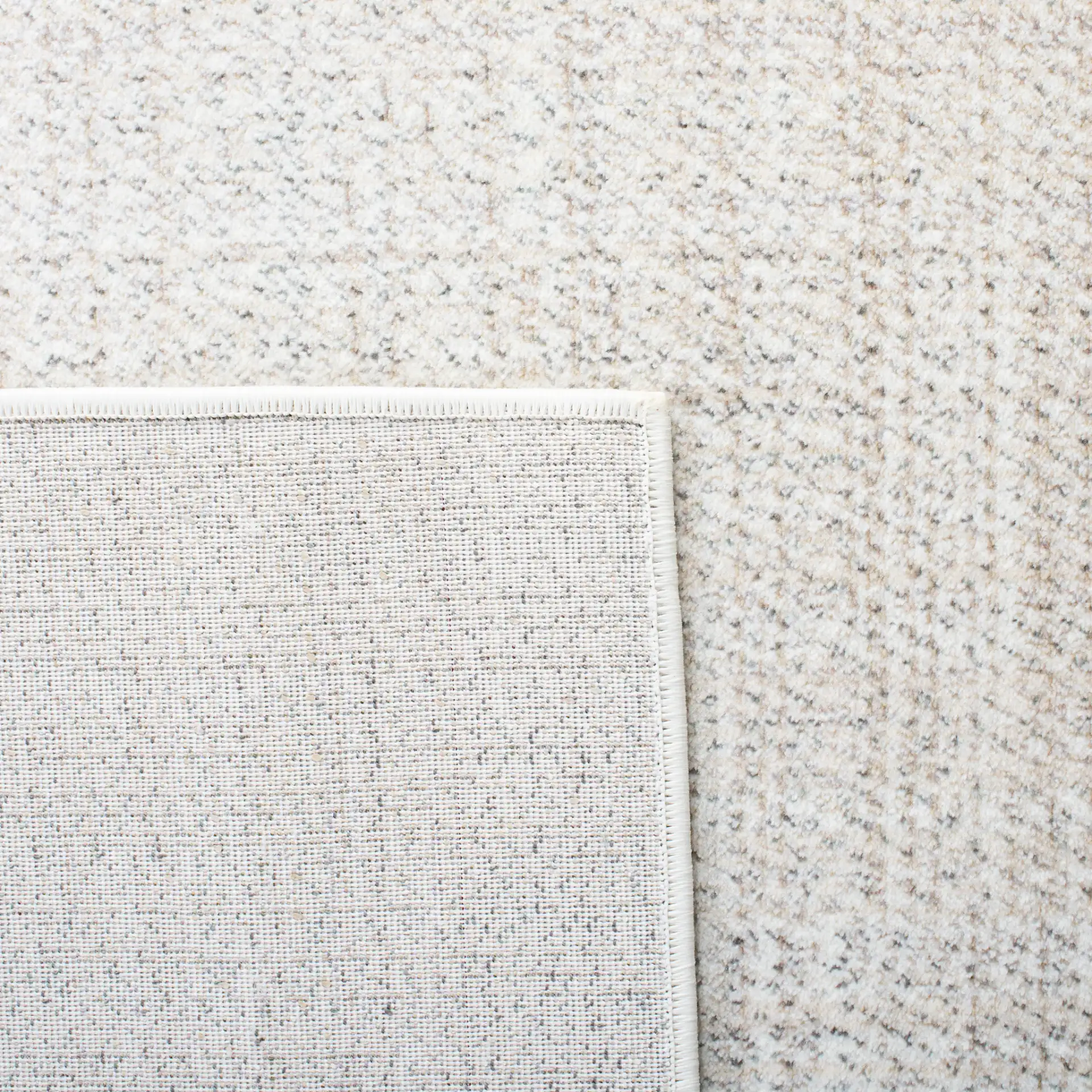 Herat Textured Solid Rug in Ivory / Beige in a styled room