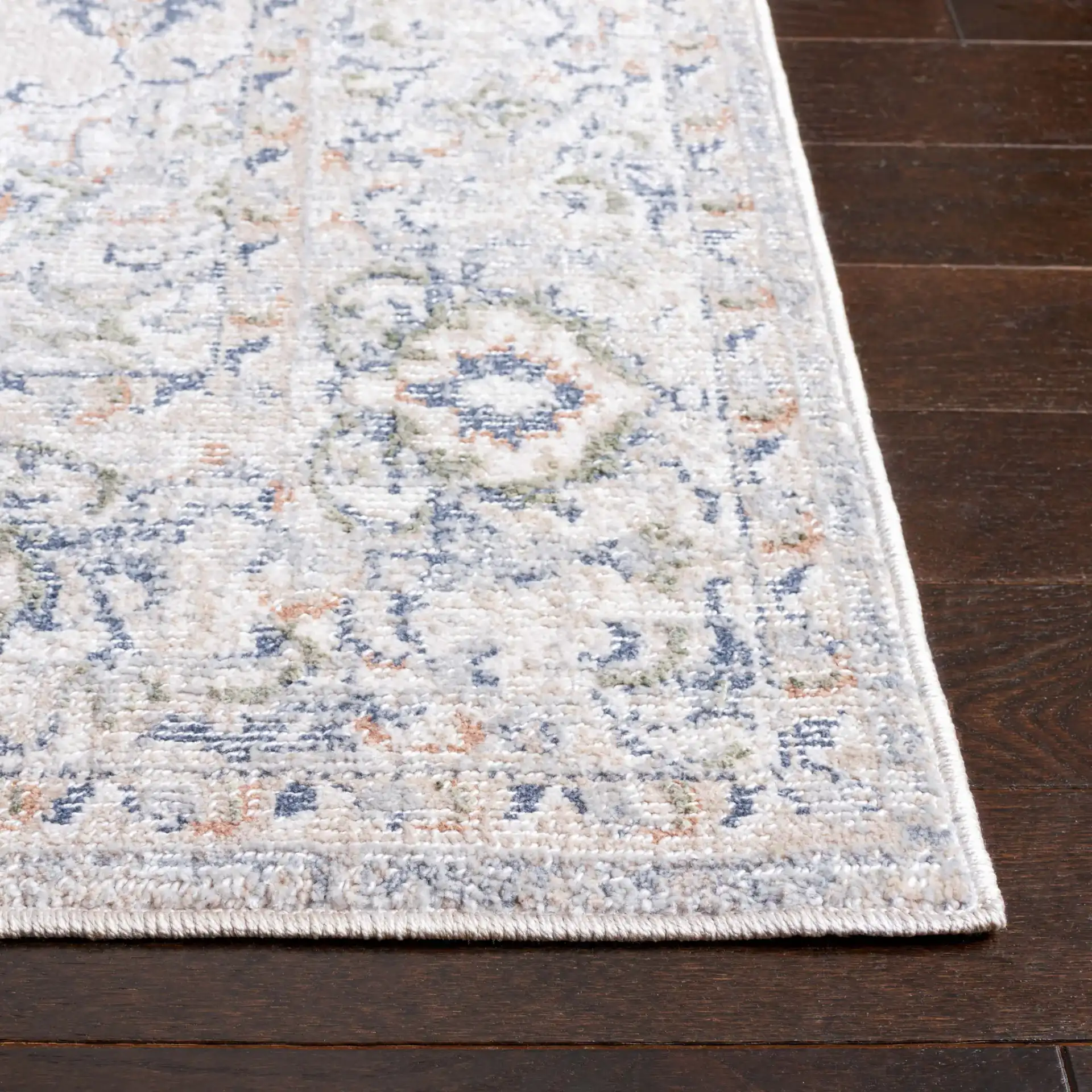Hunter Distressed Medallion Rug in Ivory Gray / Dark Gray / Beige in a styled room