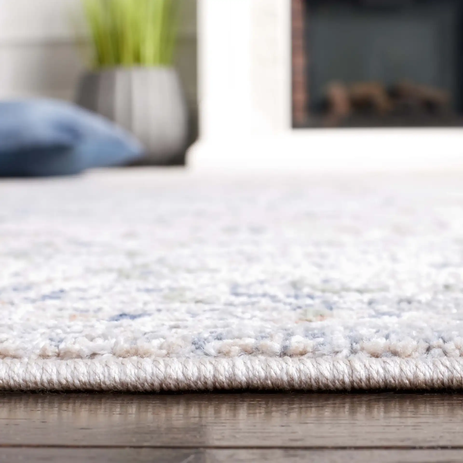 Hunter Distressed Medallion Rug in Ivory Gray / Dark Gray / Beige in a styled room