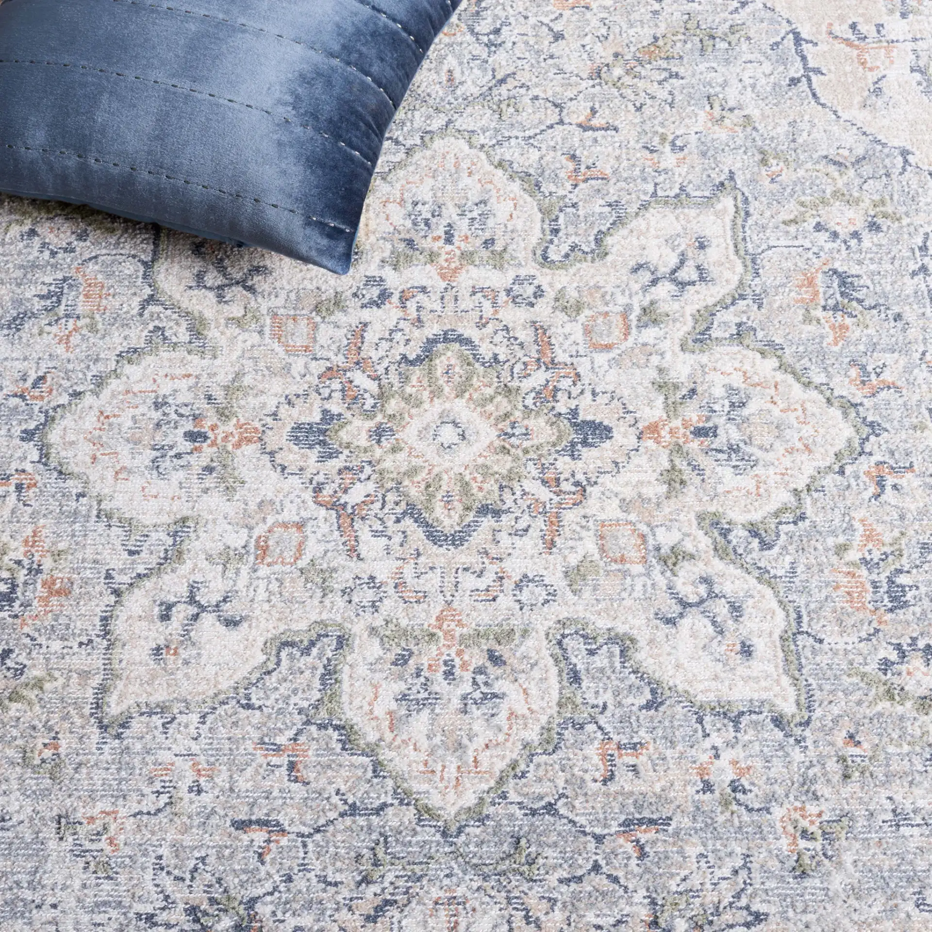 Hunter Distressed Medallion Rug in Ivory Gray / Dark Gray / Beige in a styled room