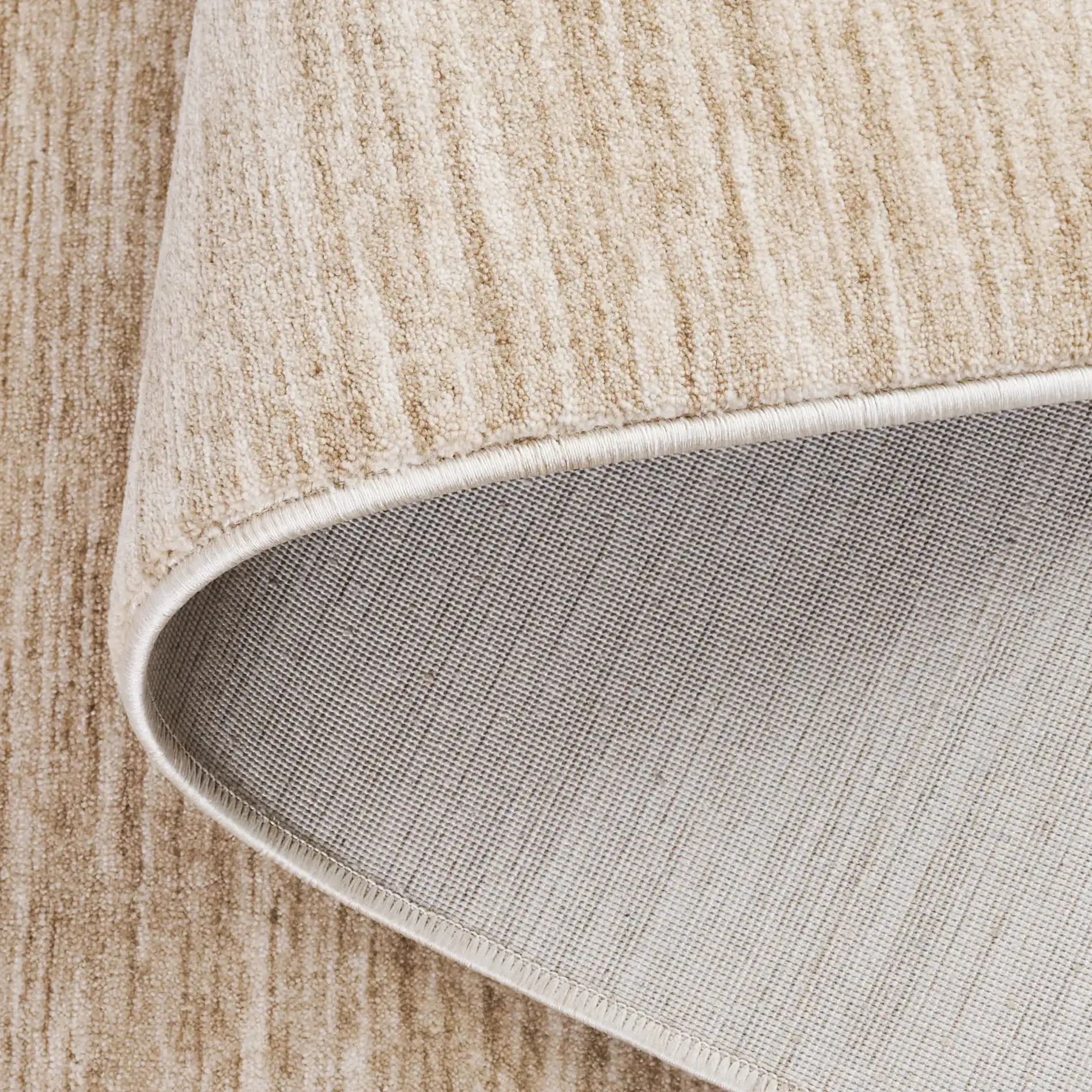 Haven Heathered Solid Rug in Beige in a styled room