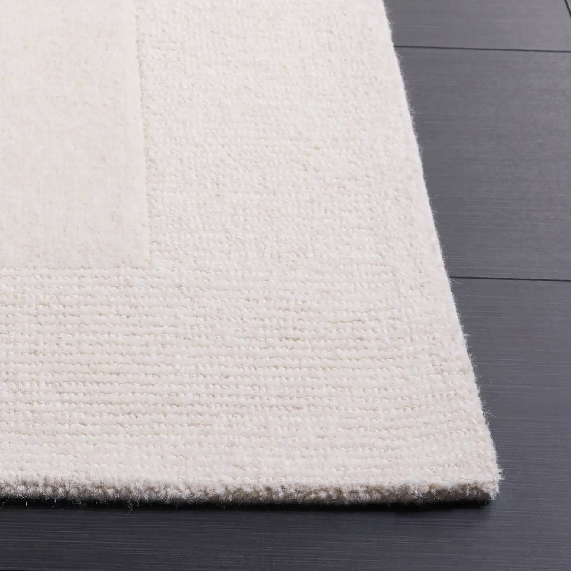 Harvest Ribbed Border Hand-Tufted Wool Rug in Ivory in a styled room