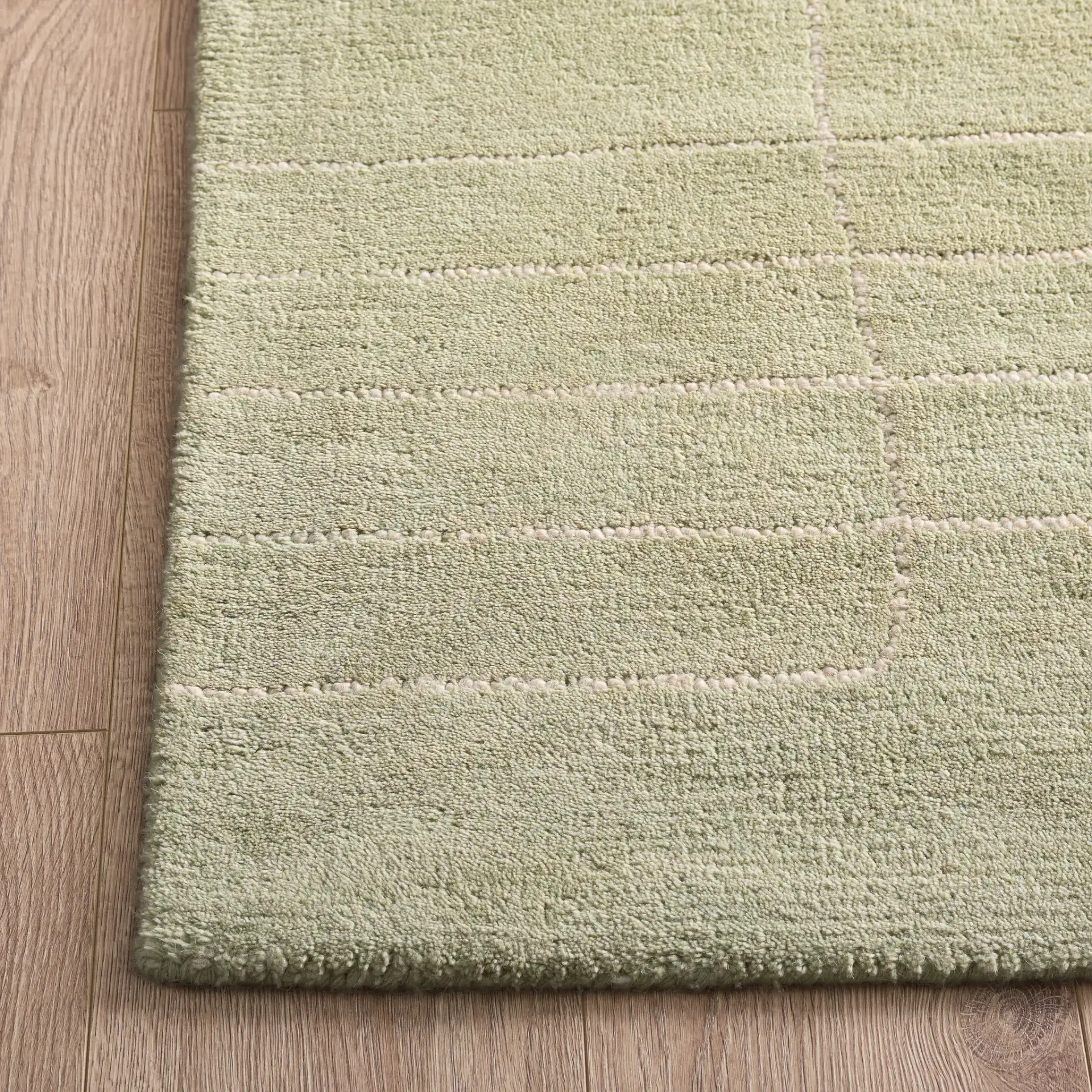 Harvest Dotted Line Hand-Tufted Wool Rug in Sage in a styled room