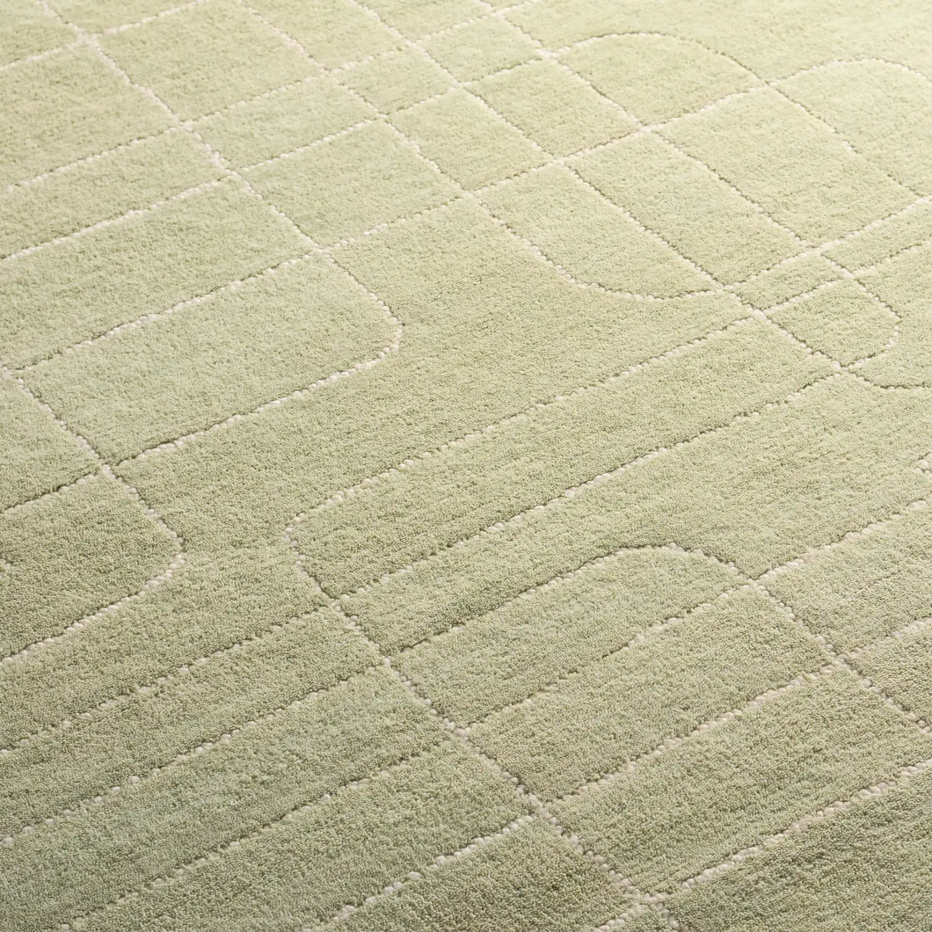 Harvest Dotted Line Hand-Tufted Wool Rug in Sage in a styled room