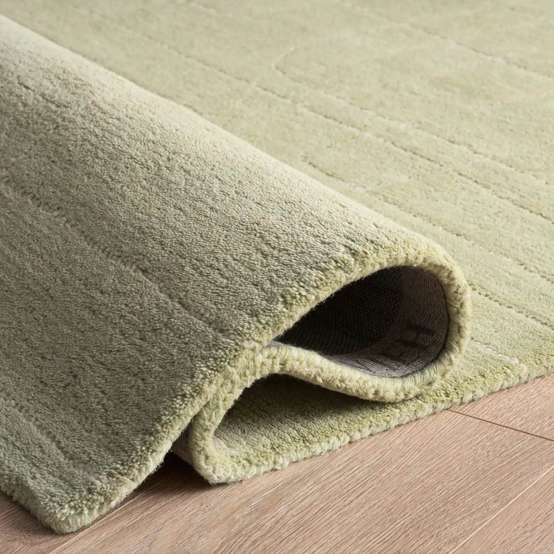 Harvest Dotted Line Hand-Tufted Wool Rug in Sage in a styled room