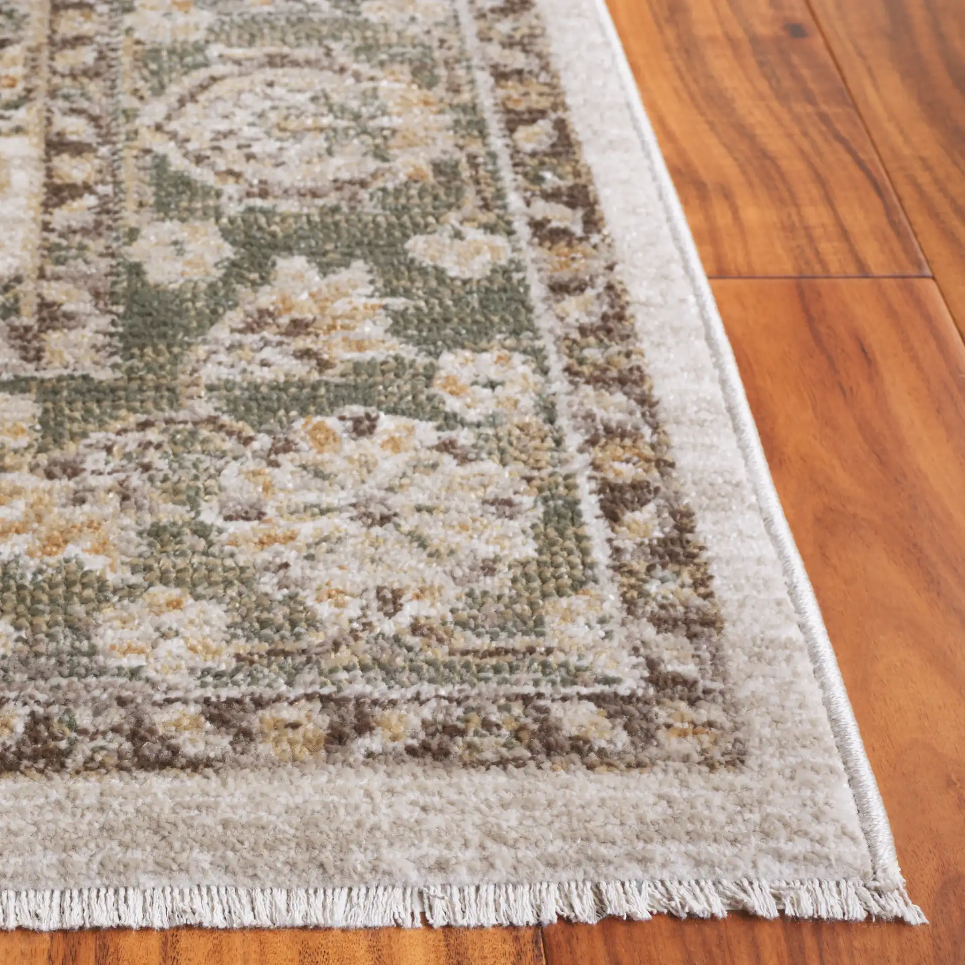 Hazel Medallion Bordered Rug in Green / Brown in a styled room