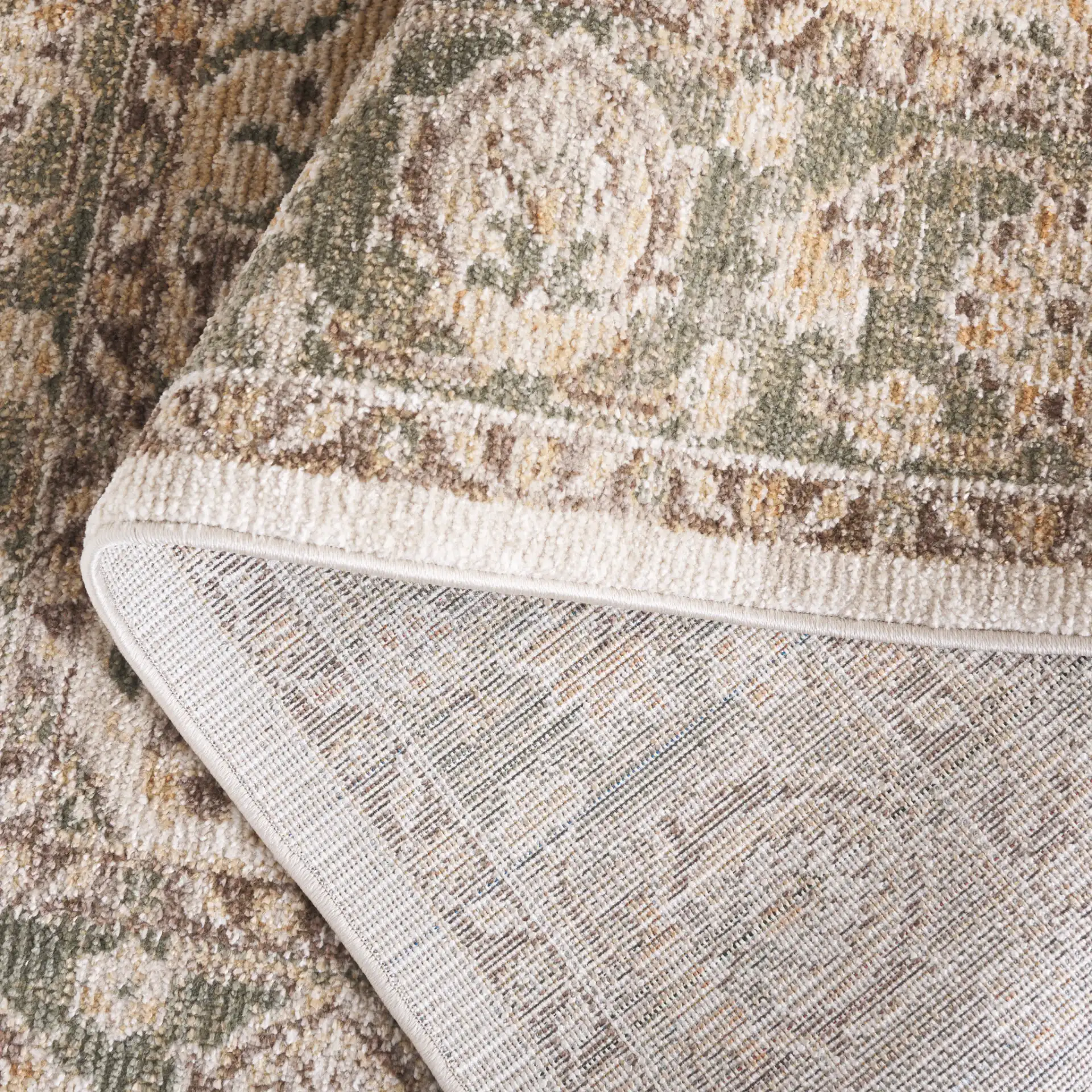 Hazel Medallion Bordered Rug in Green / Brown in a styled room