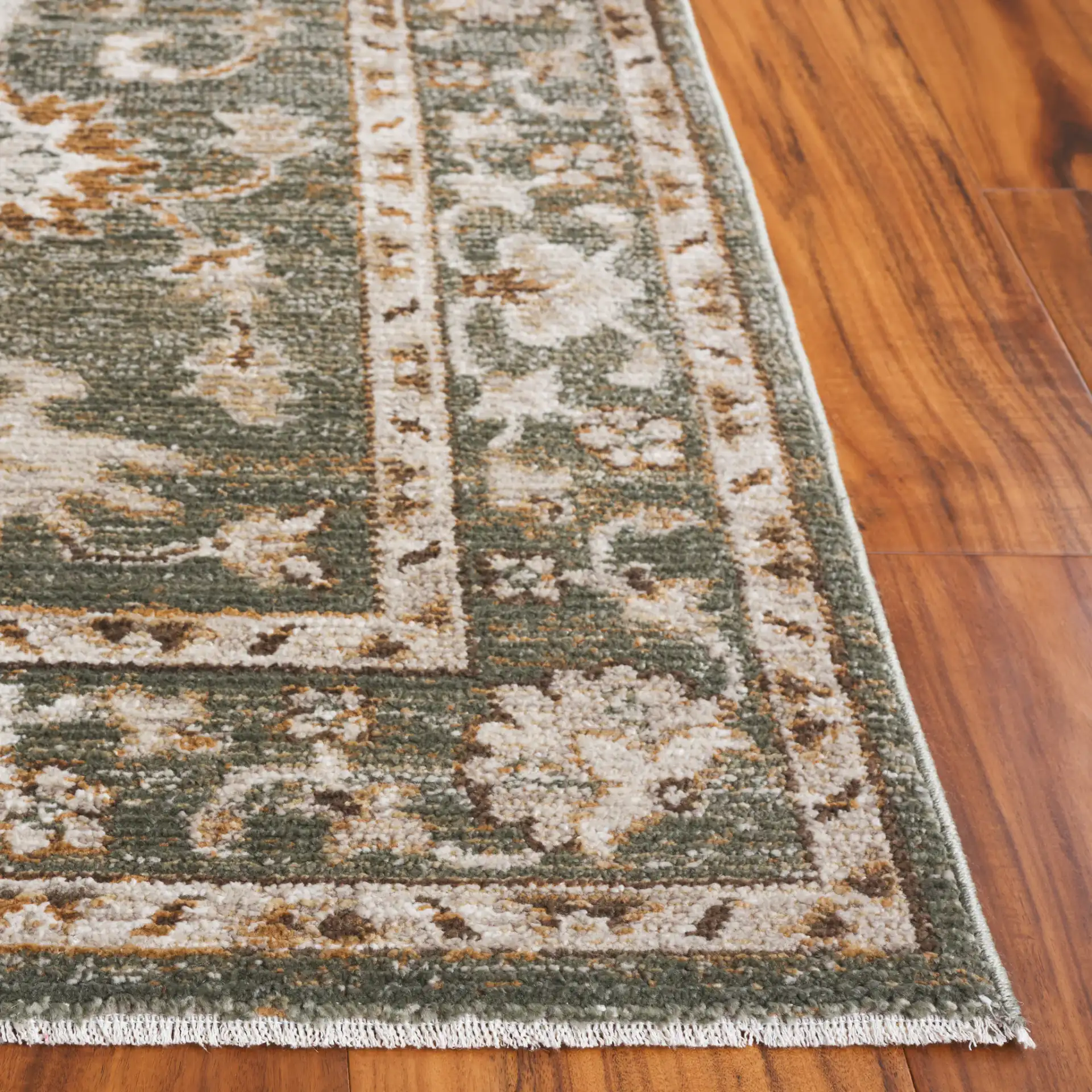 Hazel Botanical Bordered Rug in Green / Ivory in a styled room