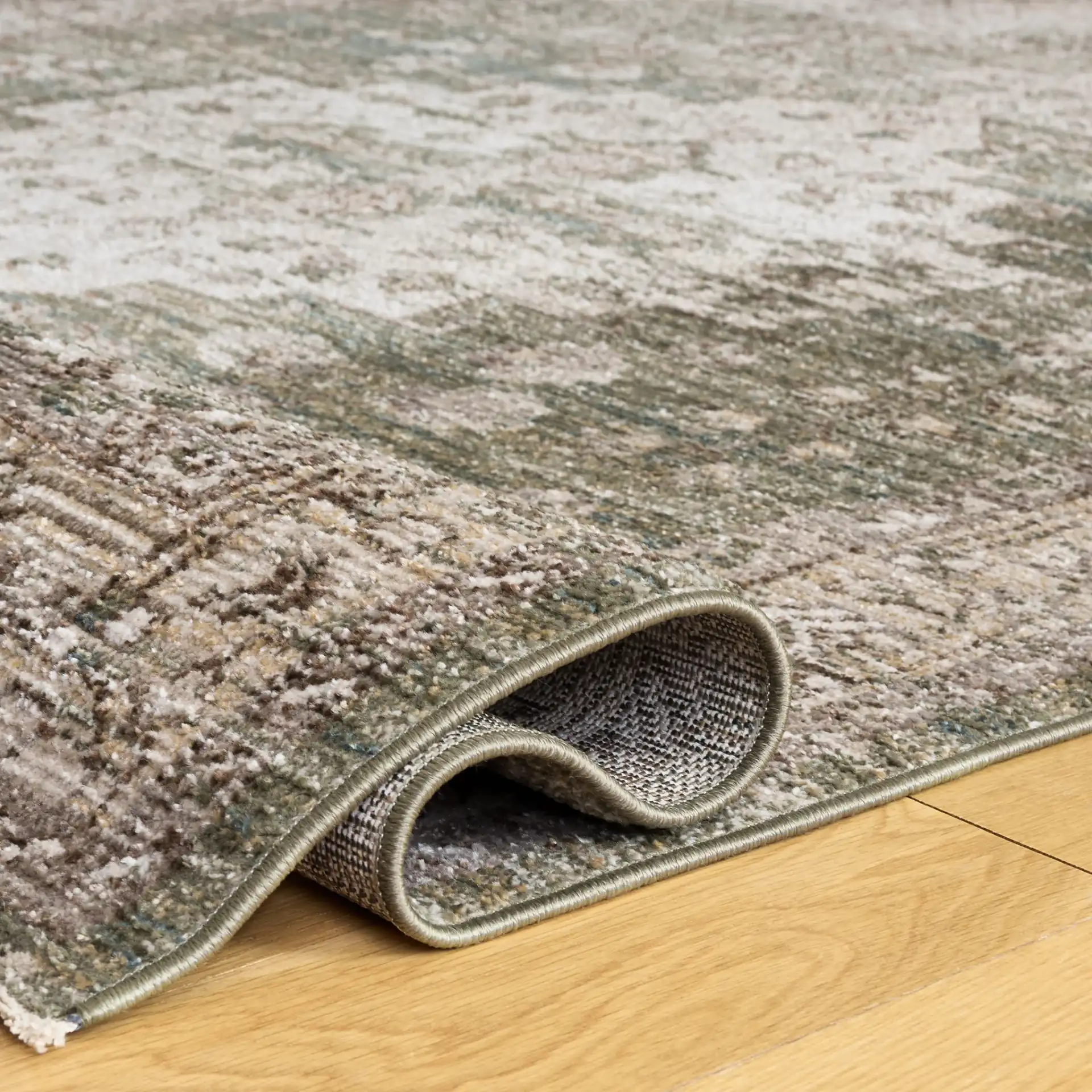 Hazel Distressed Medallion Rug in Green / Beige in a styled room