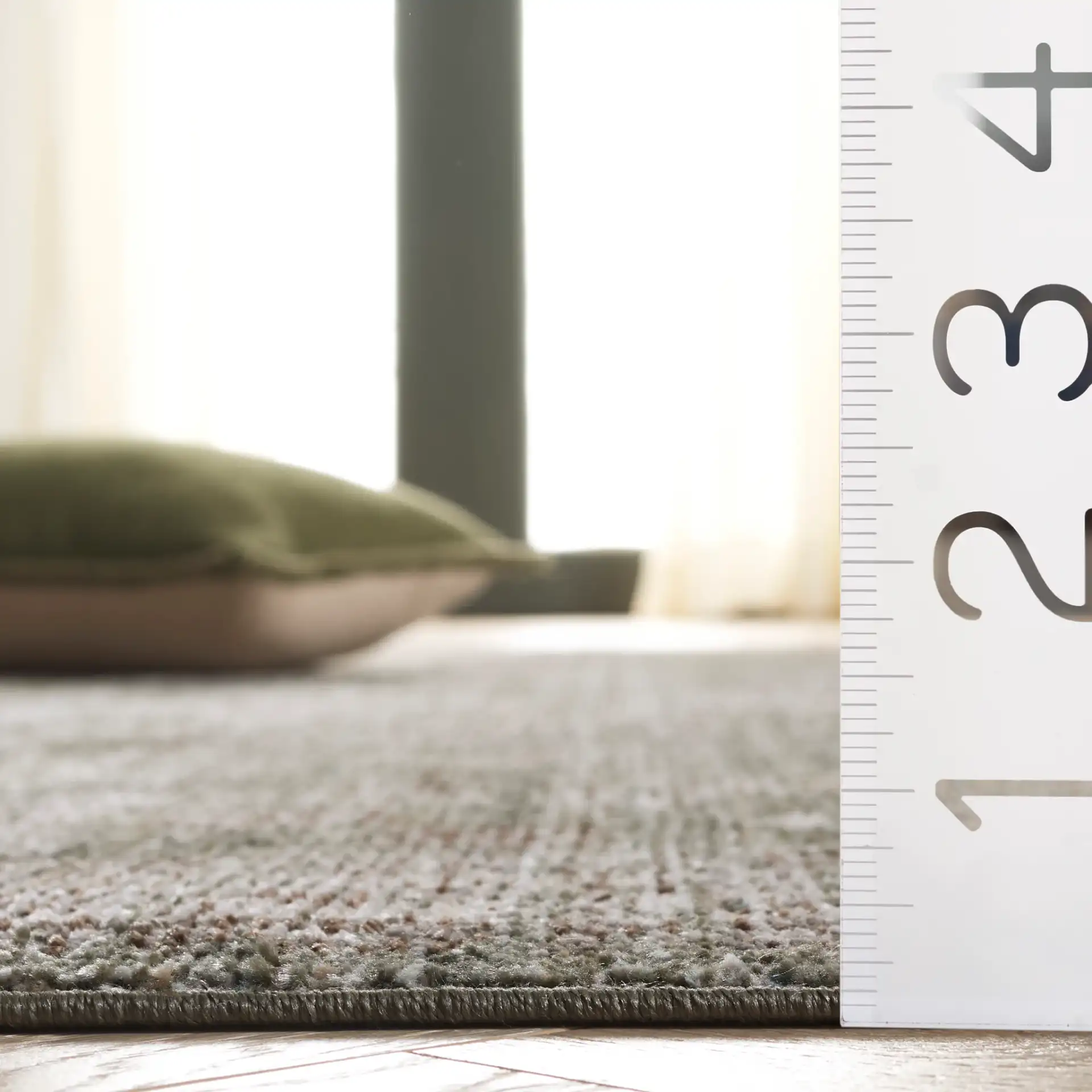 Hazel Distressed Medallion Rug in Green / Beige in a styled room