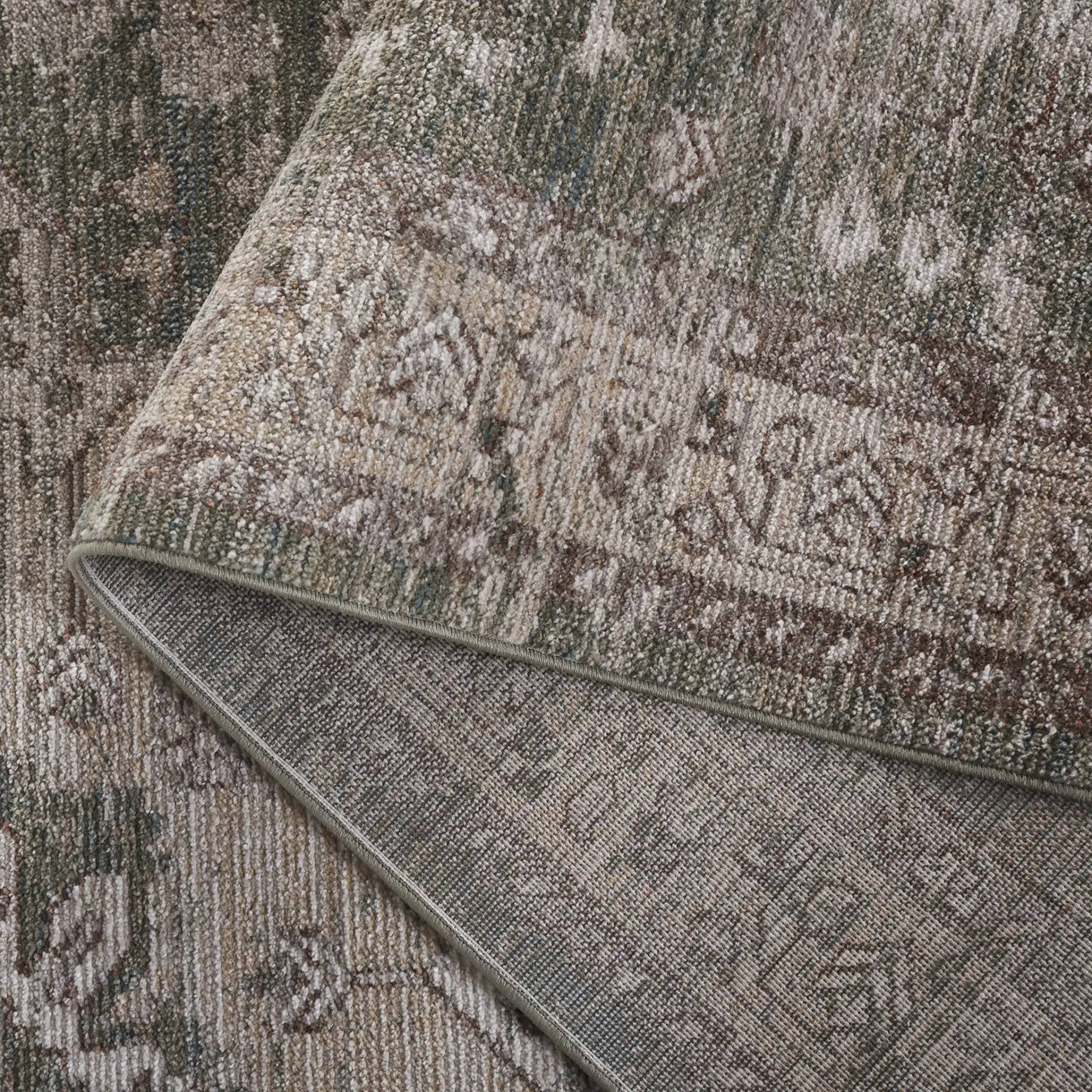 Hazel Distressed Medallion Rug in Green / Beige in a styled room