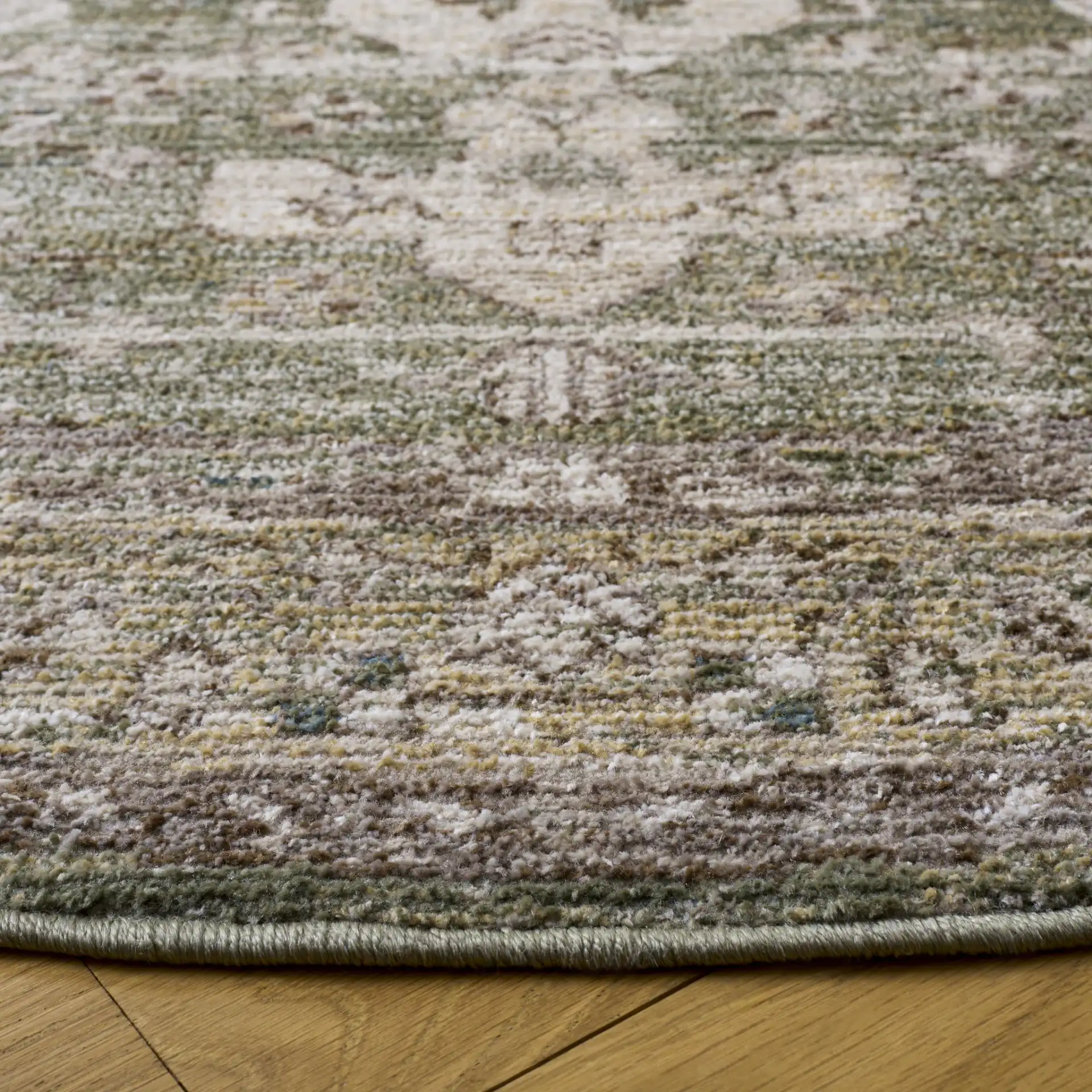 Hazel Distressed Medallion Rug in Green / Beige in a styled room