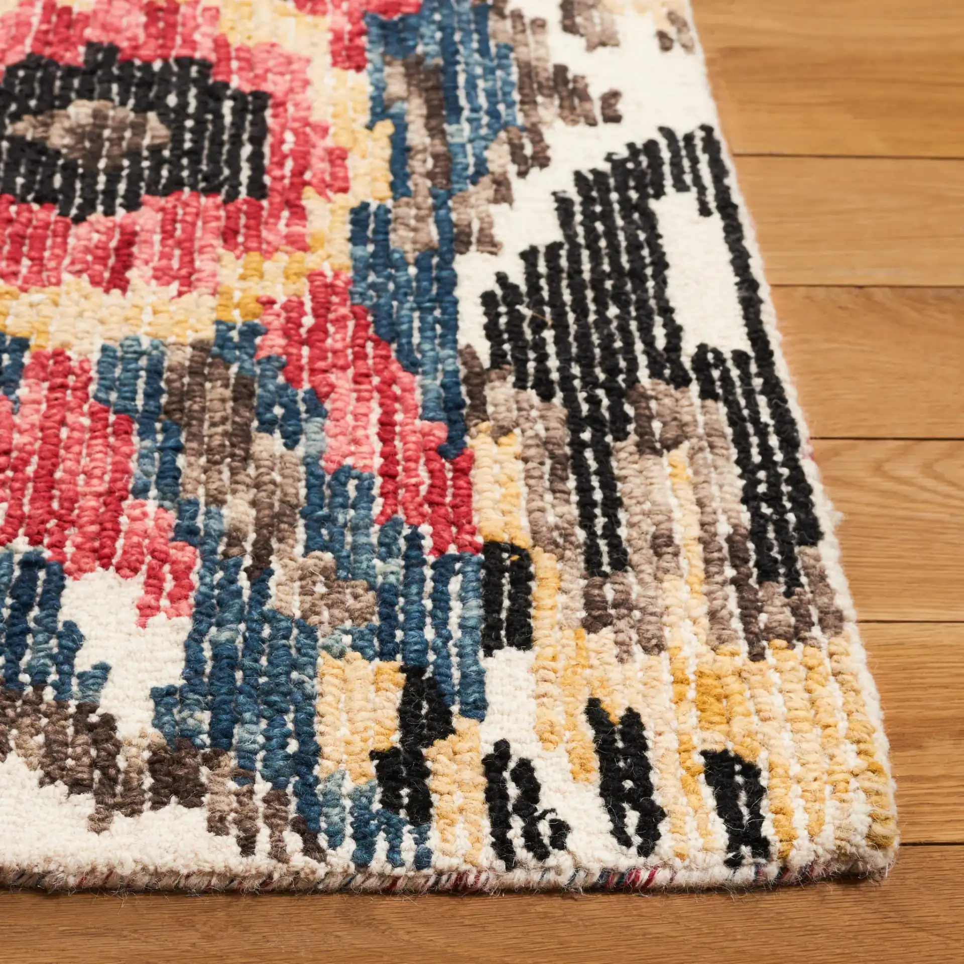 Ikat Bohemian Feathered Wave Hand-Tufted Wool Rug in Black / Red in a styled room
