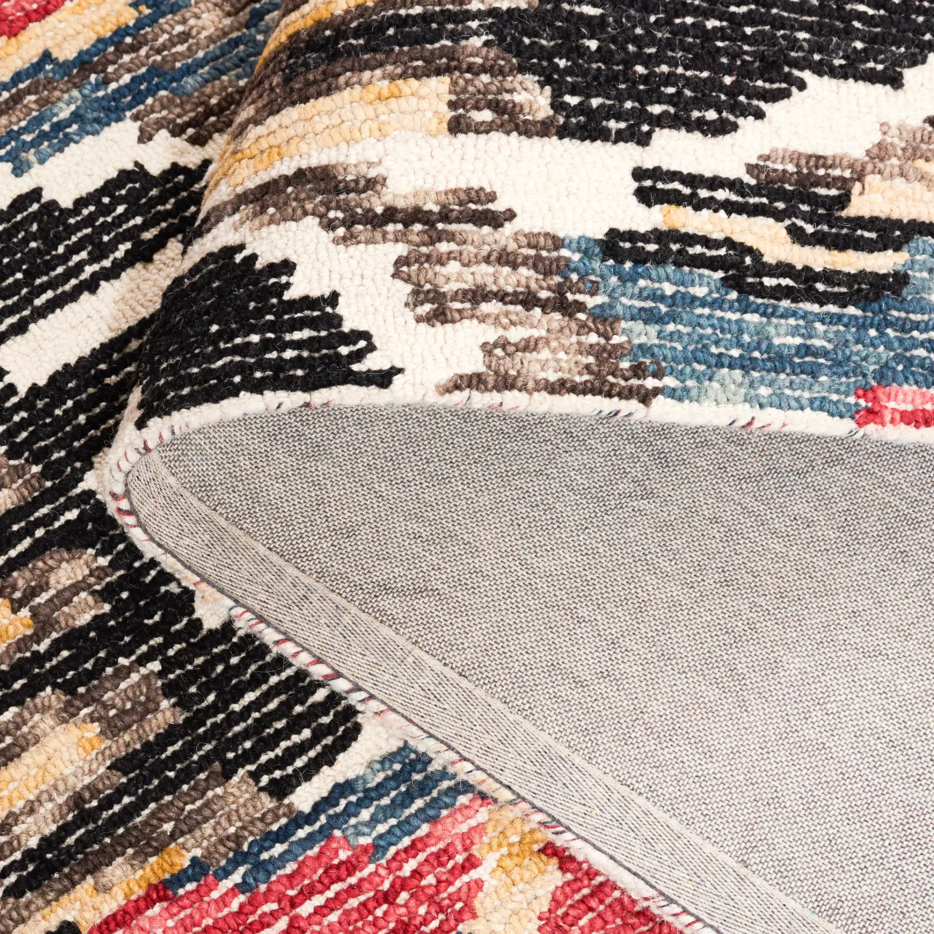 Ikat Bohemian Feathered Wave Hand-Tufted Wool Rug in Black / Red in a styled room