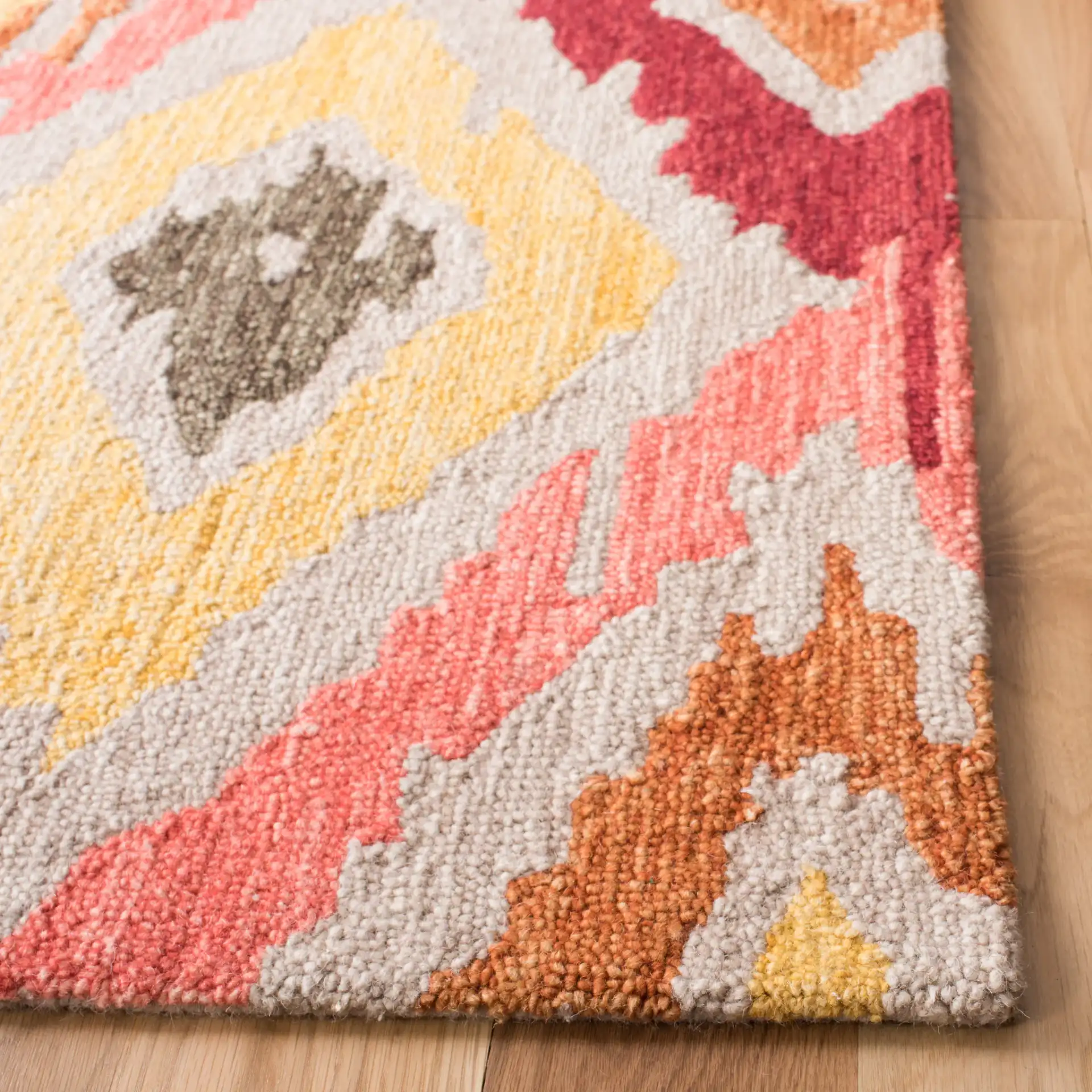Ikat Diamond Hand-Tufted Wool Rug in Beige / Pink in a styled room