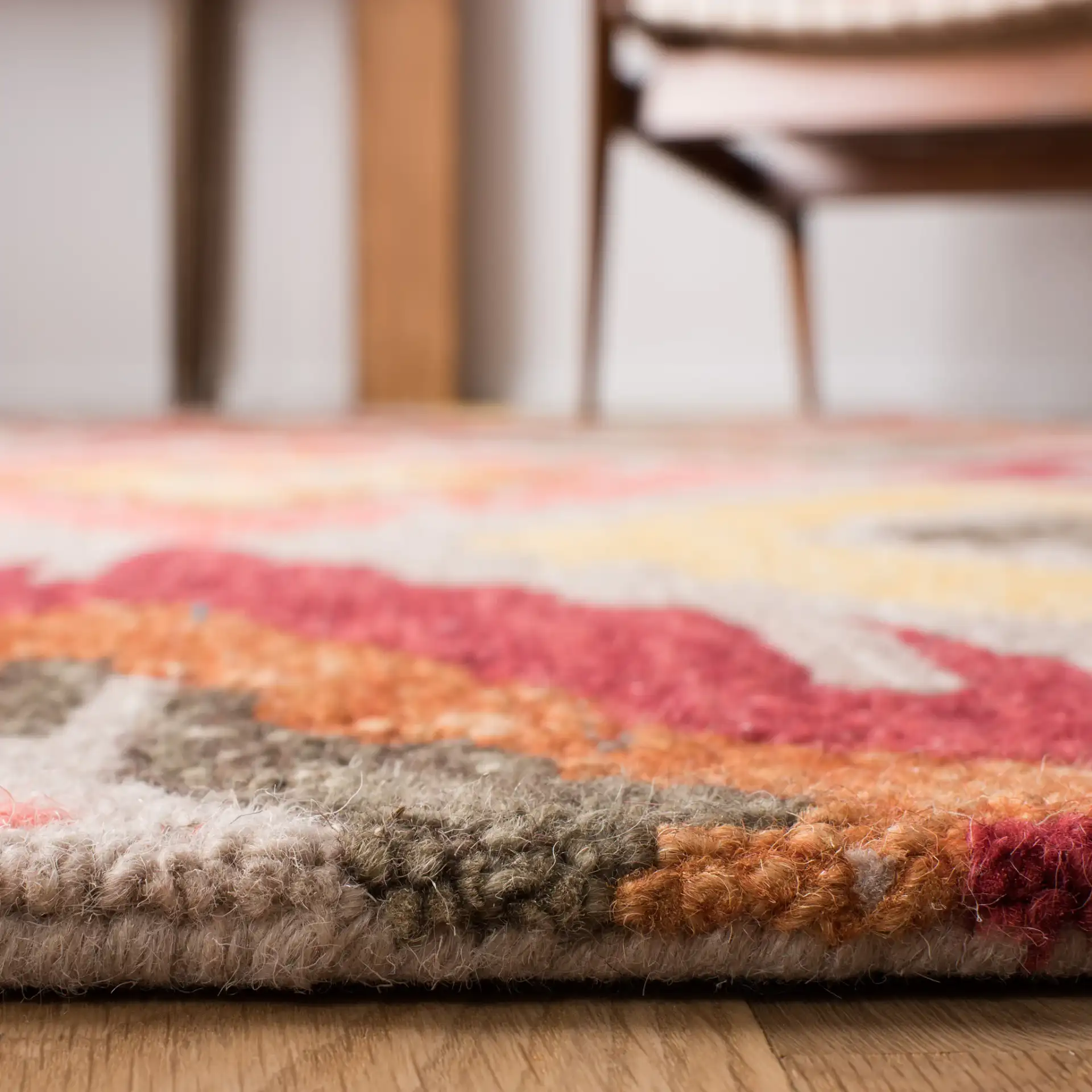 Ikat Diamond Hand-Tufted Wool Rug in Beige / Pink in a styled room