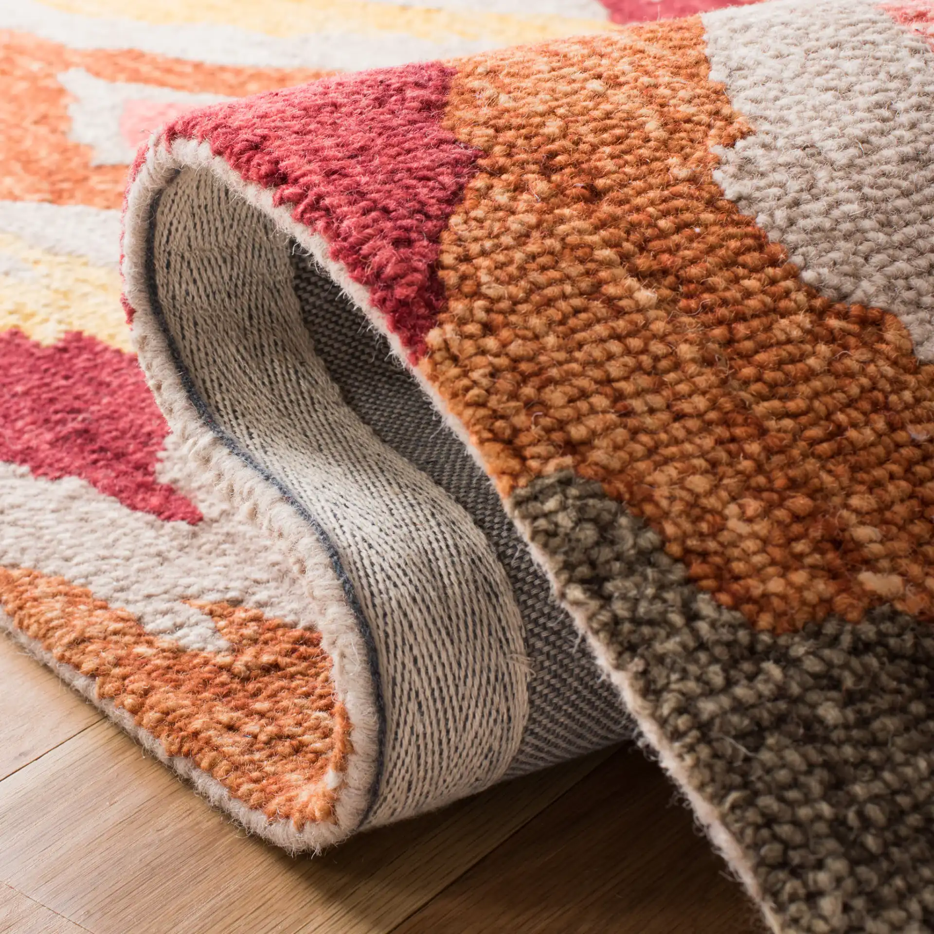 Ikat Diamond Hand-Tufted Wool Rug in Beige / Pink in a styled room