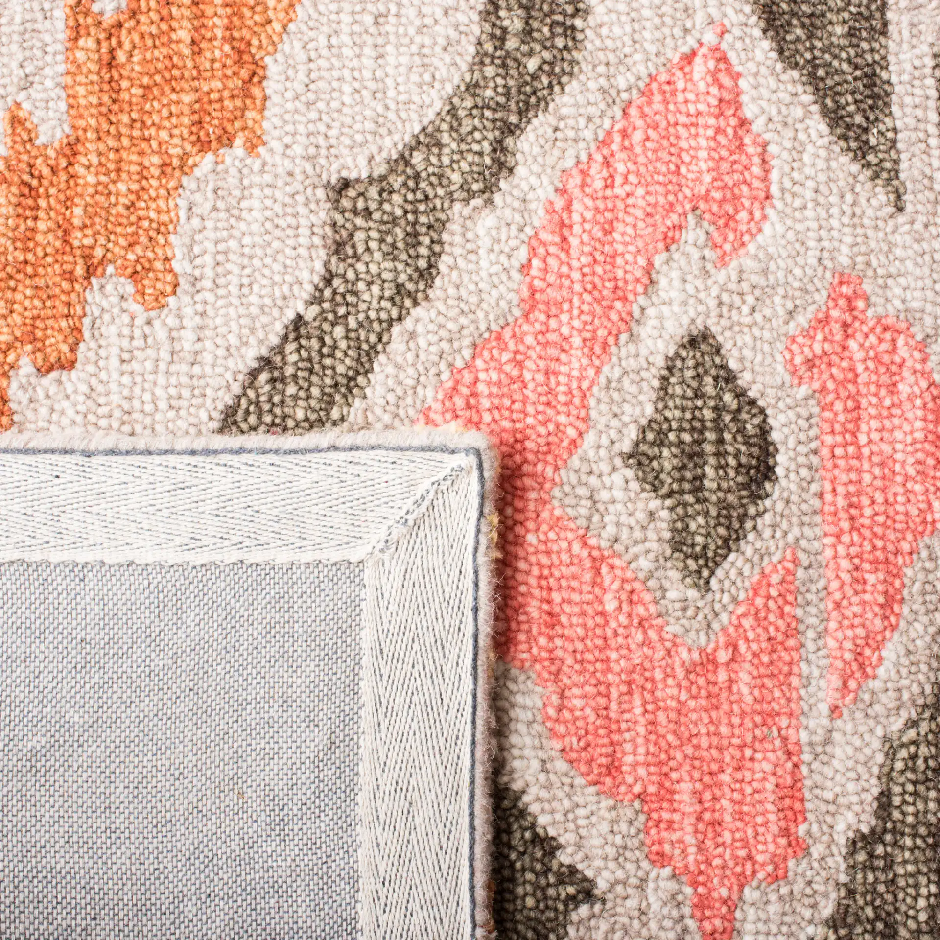 Ikat Diamond Hand-Tufted Wool Rug in Beige / Pink in a styled room