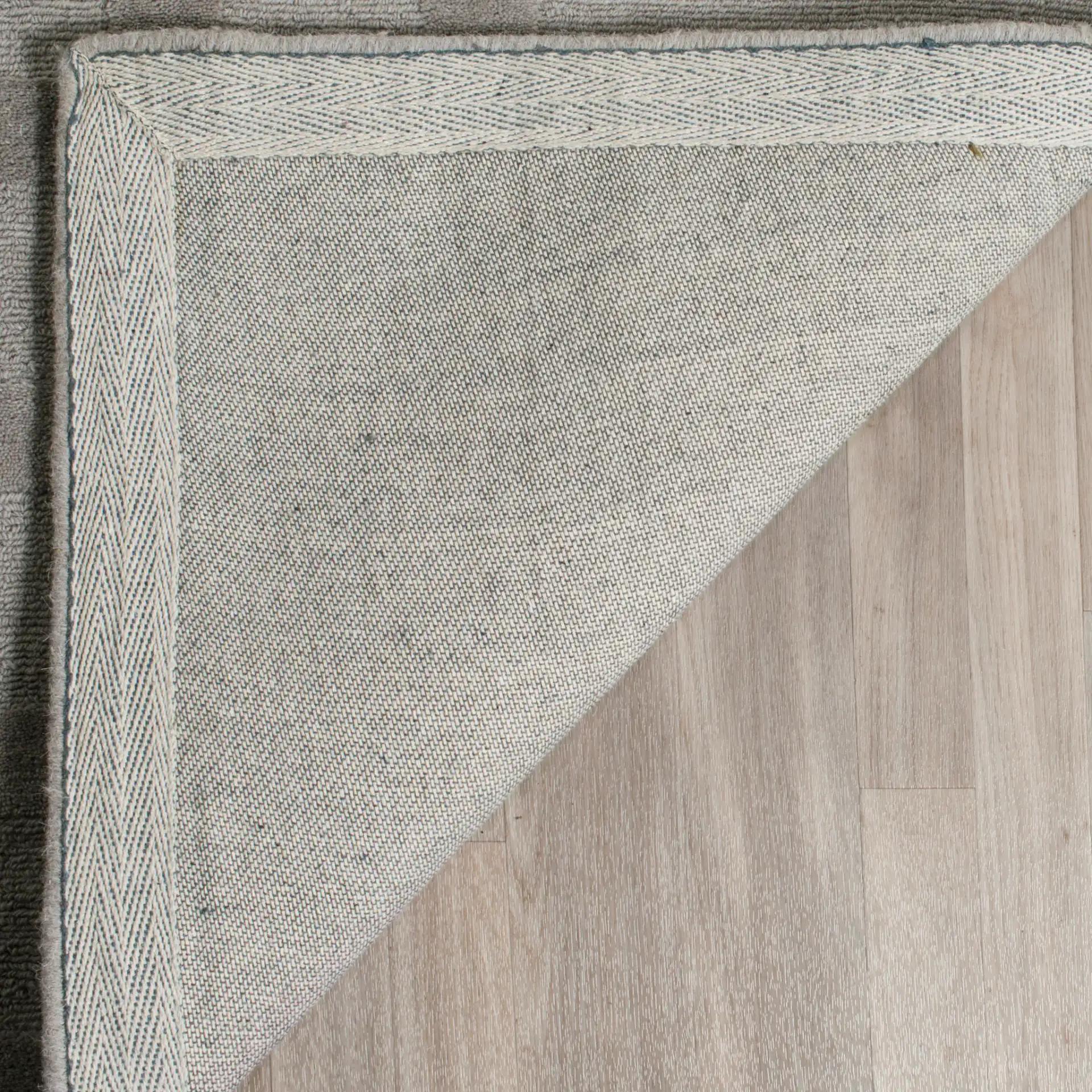 Impressions Interlocking Grid Hand-Loomed Wool Rug in Gray in a styled room