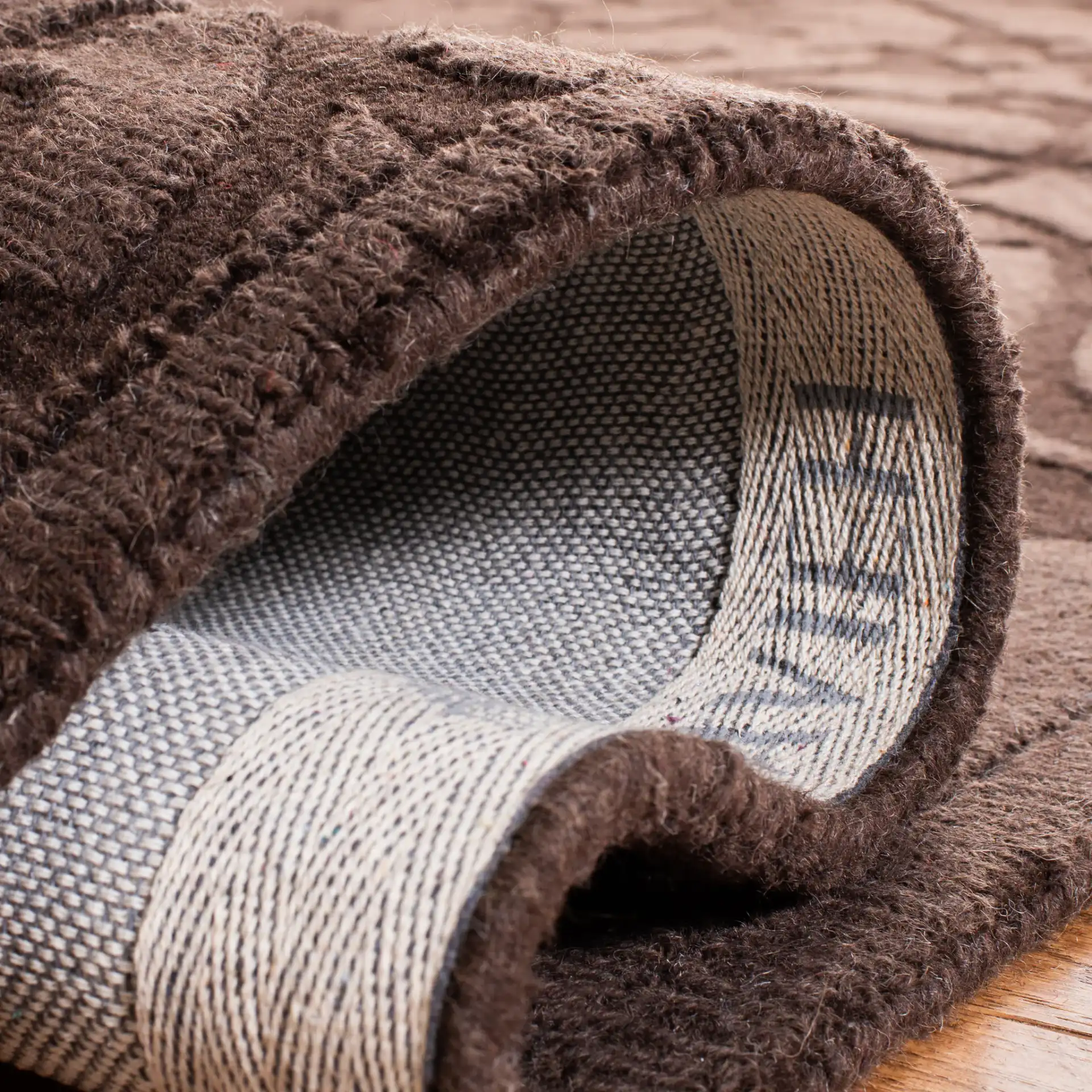 Impressions Scroll Hand-Loomed Wool Rug in Brown in a styled room