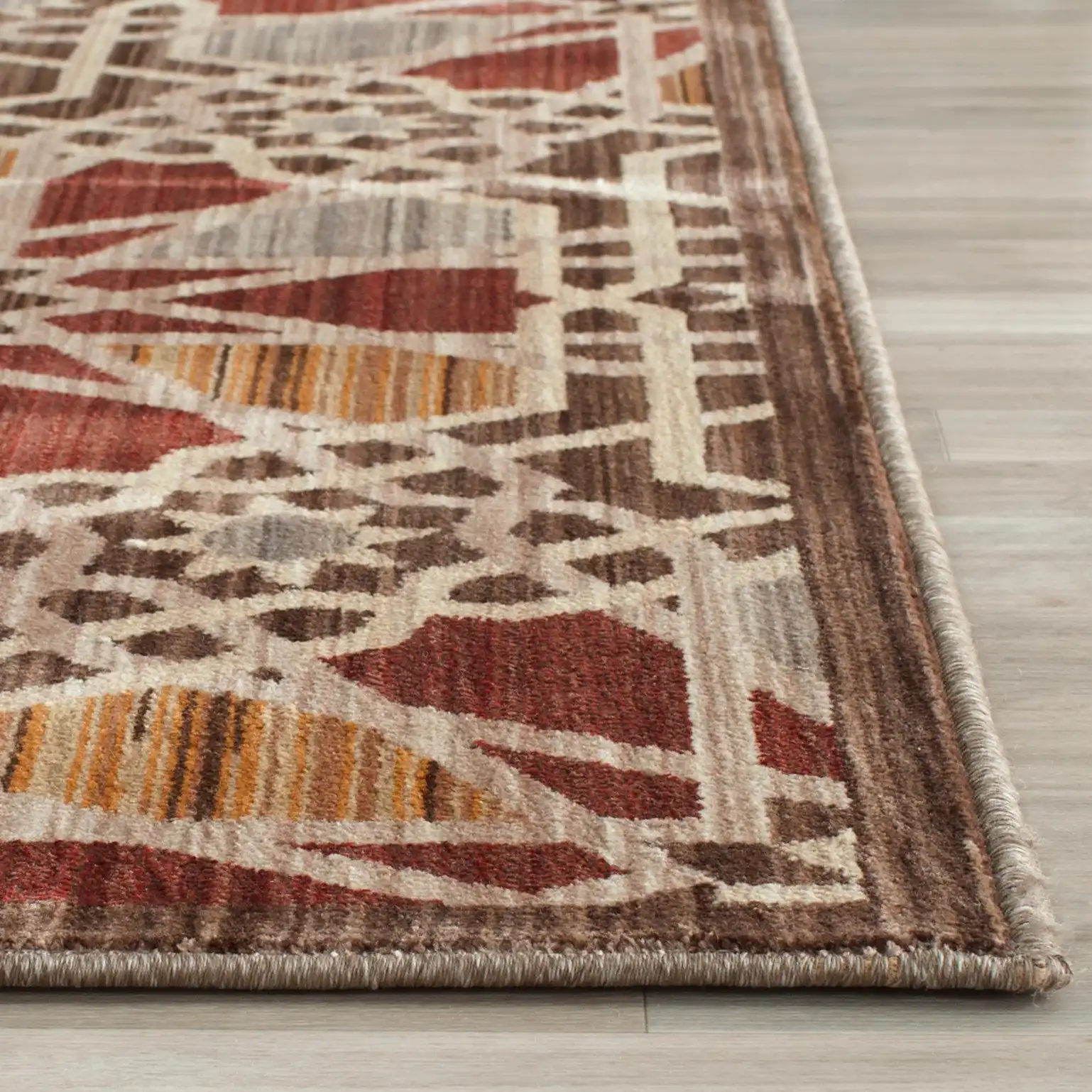Infinity Interlocking Tile Rug in Brown / Beige in a styled room