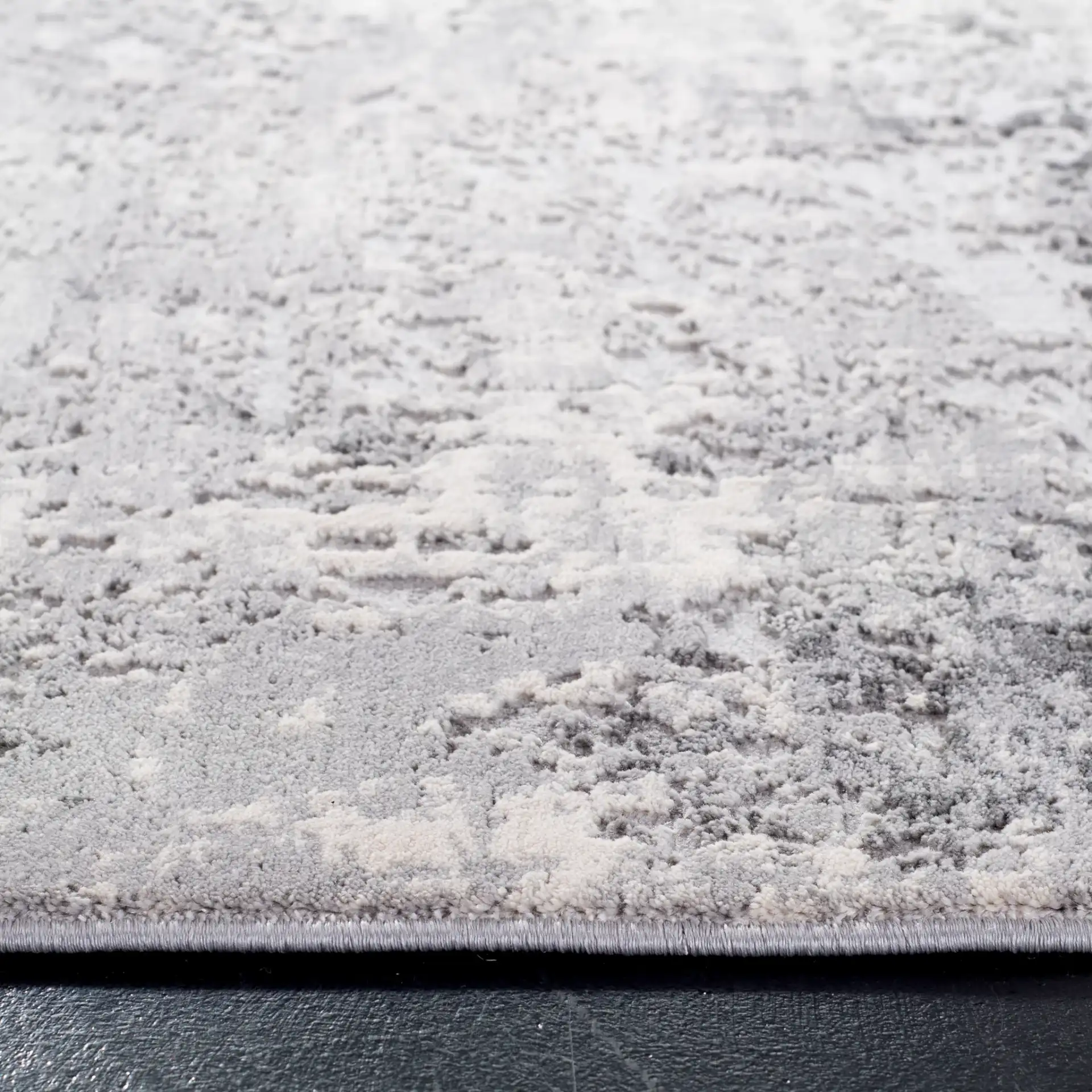 Invista Distressed Abstract Rug in Gray / Ivory in a styled room