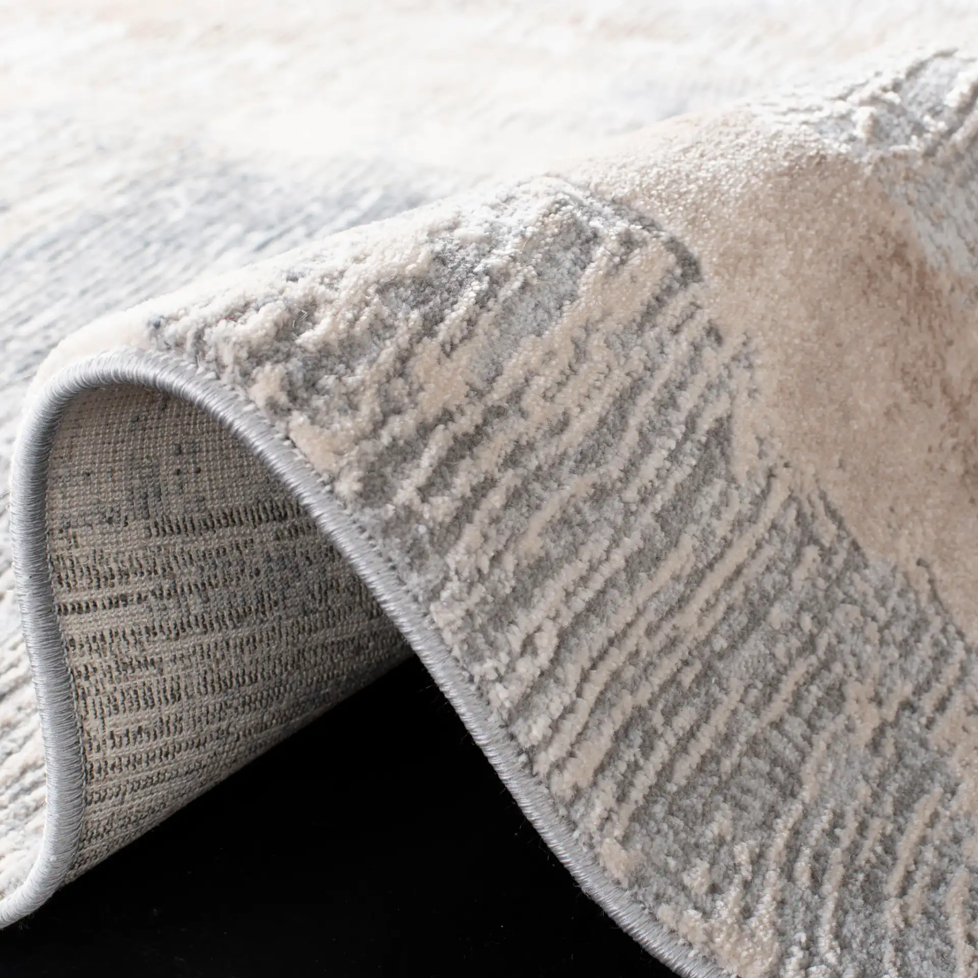 Invista Linear Abstract Rug in Cream / Gray in a styled room
