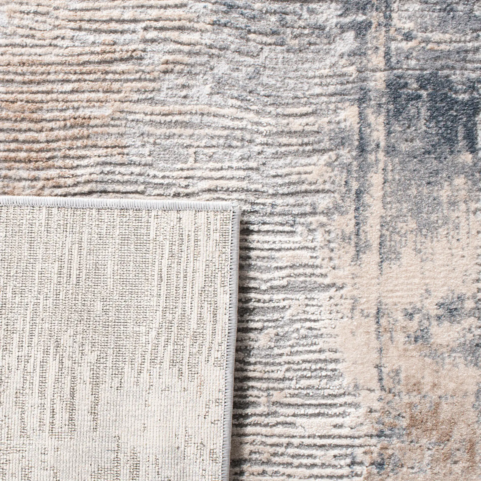 Invista Linear Abstract Rug in Cream / Gray in a styled room