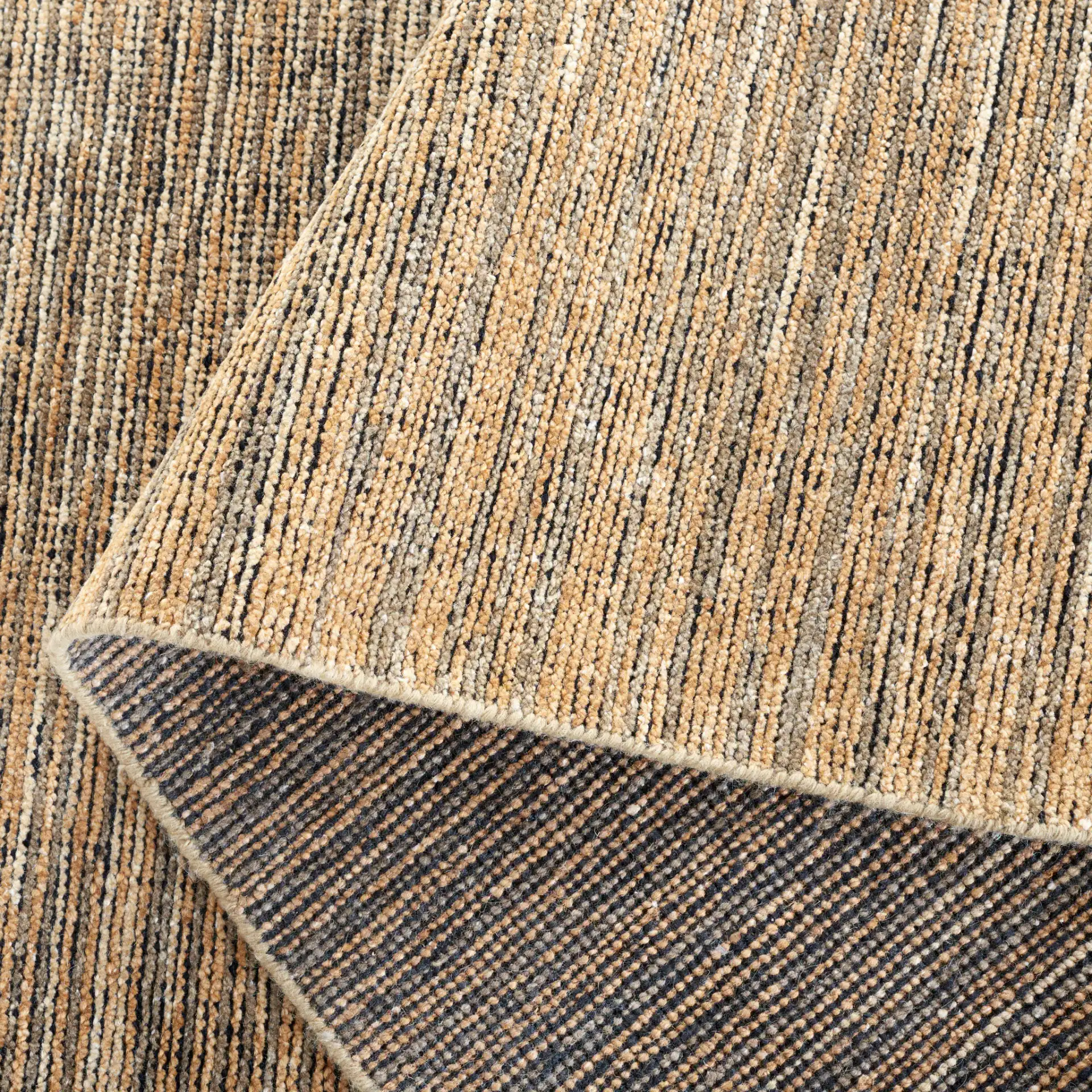 Izmir Striated Hand-Knotted Rug in Brown / Gray in a styled room