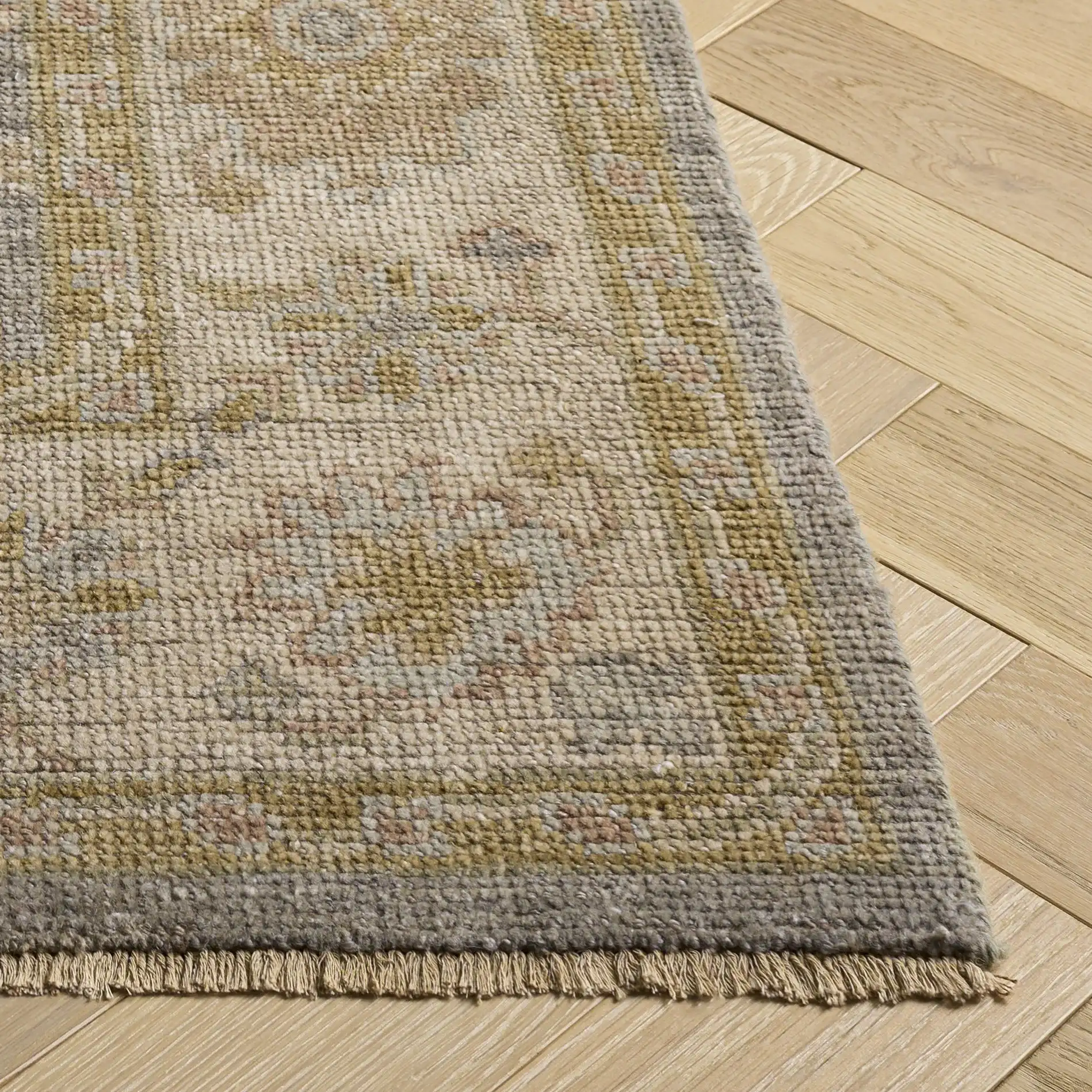 Izmir Floral Border Hand-Knotted Rug in Light Blue / Ivory in a styled room