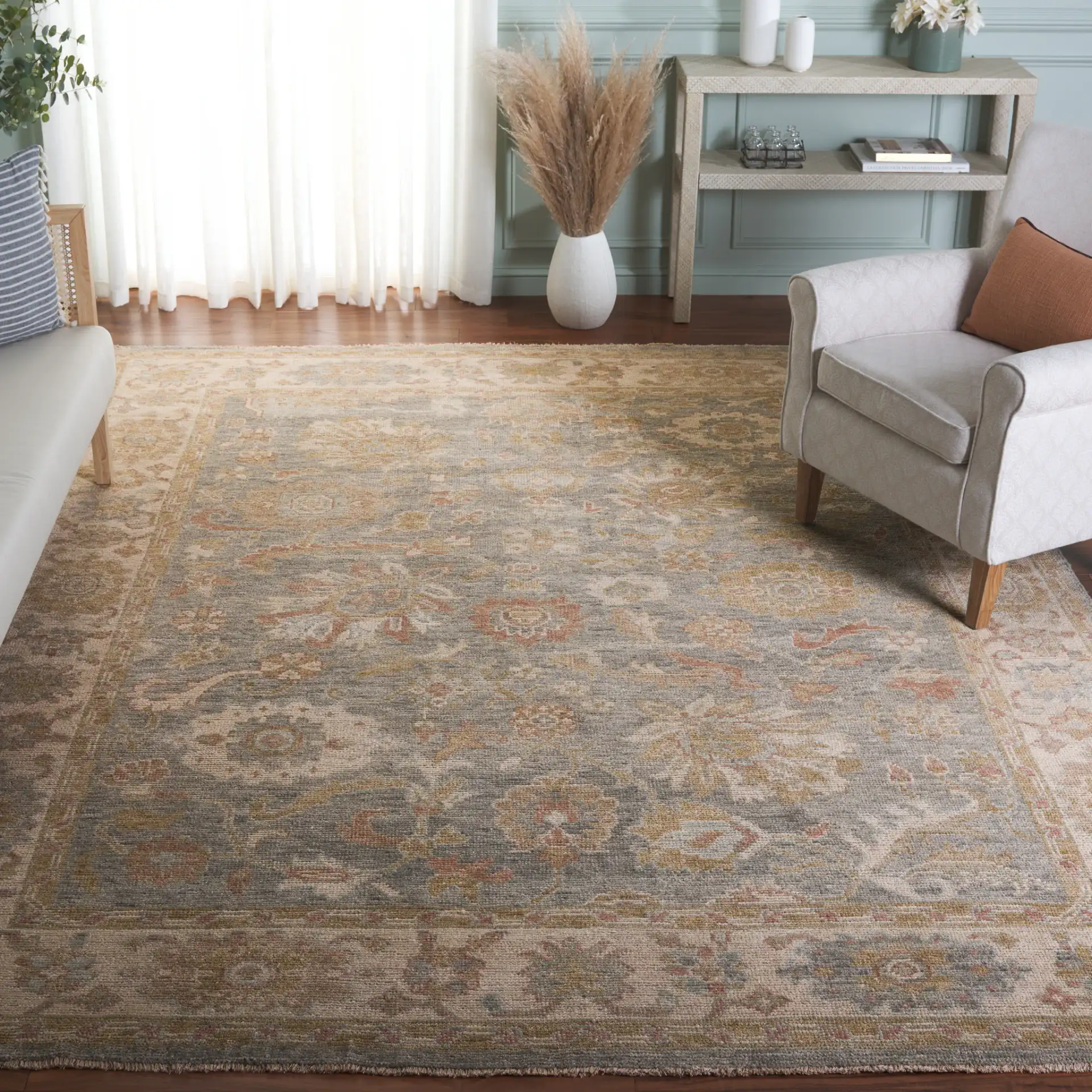 Izmir Floral Border Hand-Knotted Rug in Light Blue / Ivory in a styled room