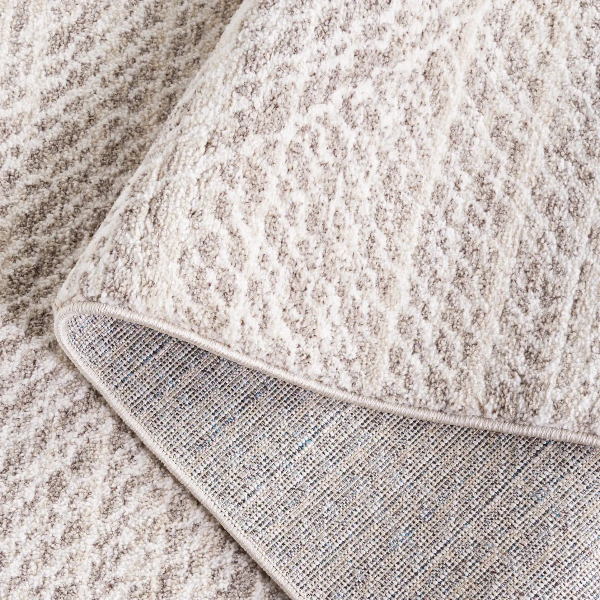 Jade Concentric Diamond Rug in Beige / Ivory in a styled room
