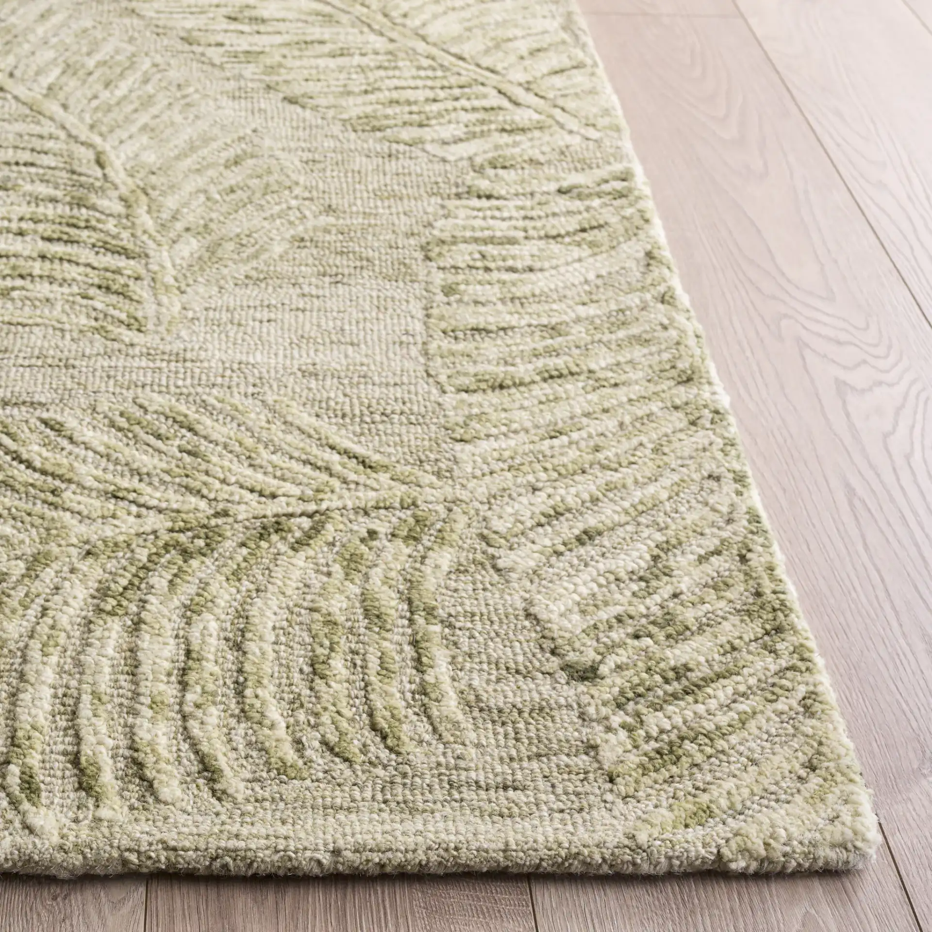Jardin Palm Leaf Hand-Tufted Wool Rug in Sage / Ivory in a styled room