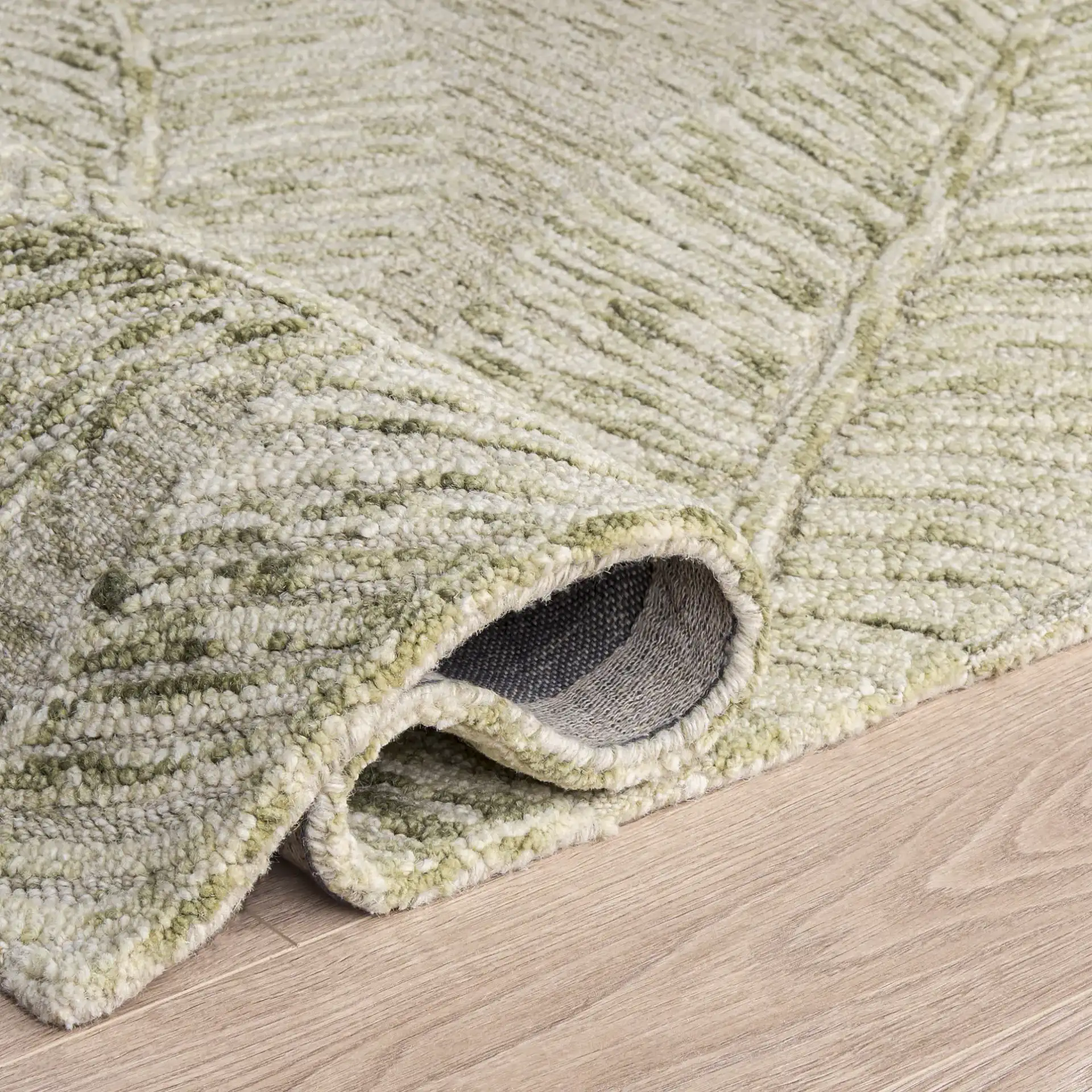 Jardin Palm Leaf Hand-Tufted Wool Rug in Sage / Ivory in a styled room
