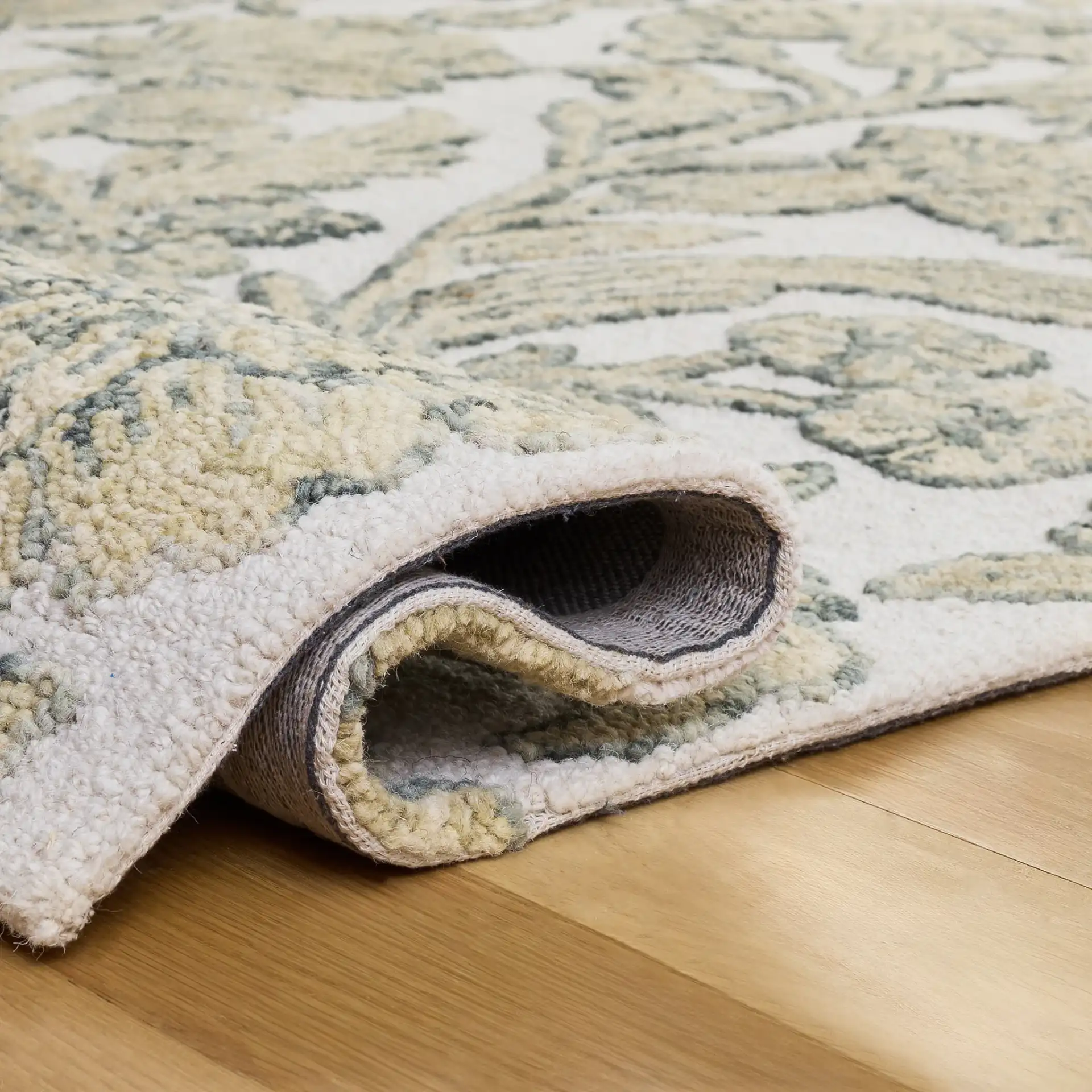 Jardin Jacobean Carnation Floral Hand-Tufted Wool Rug in Ivory / Green in a styled room