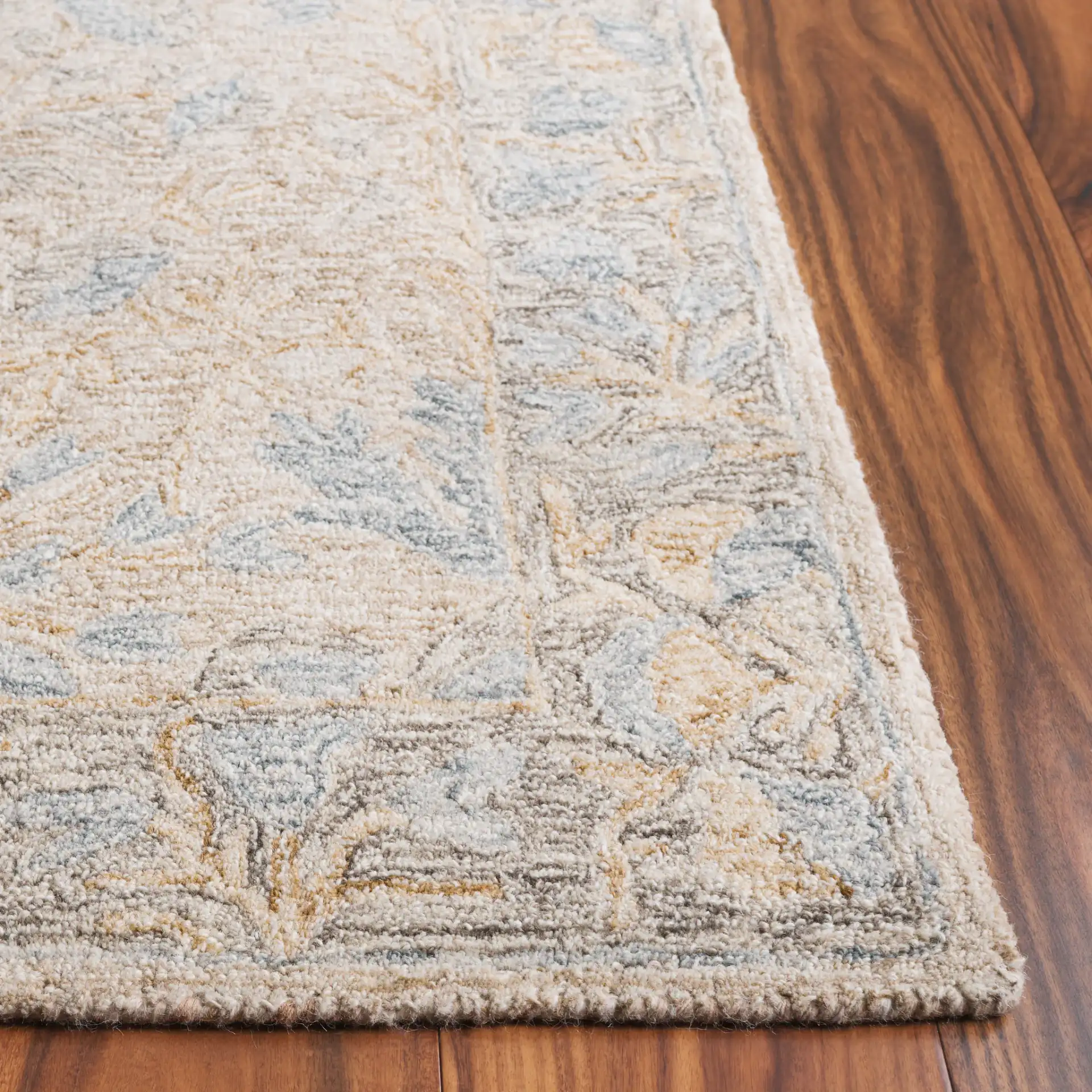 Jardin Botanical Border Hand-Tufted Wool Rug in Beige / Gray in a styled room