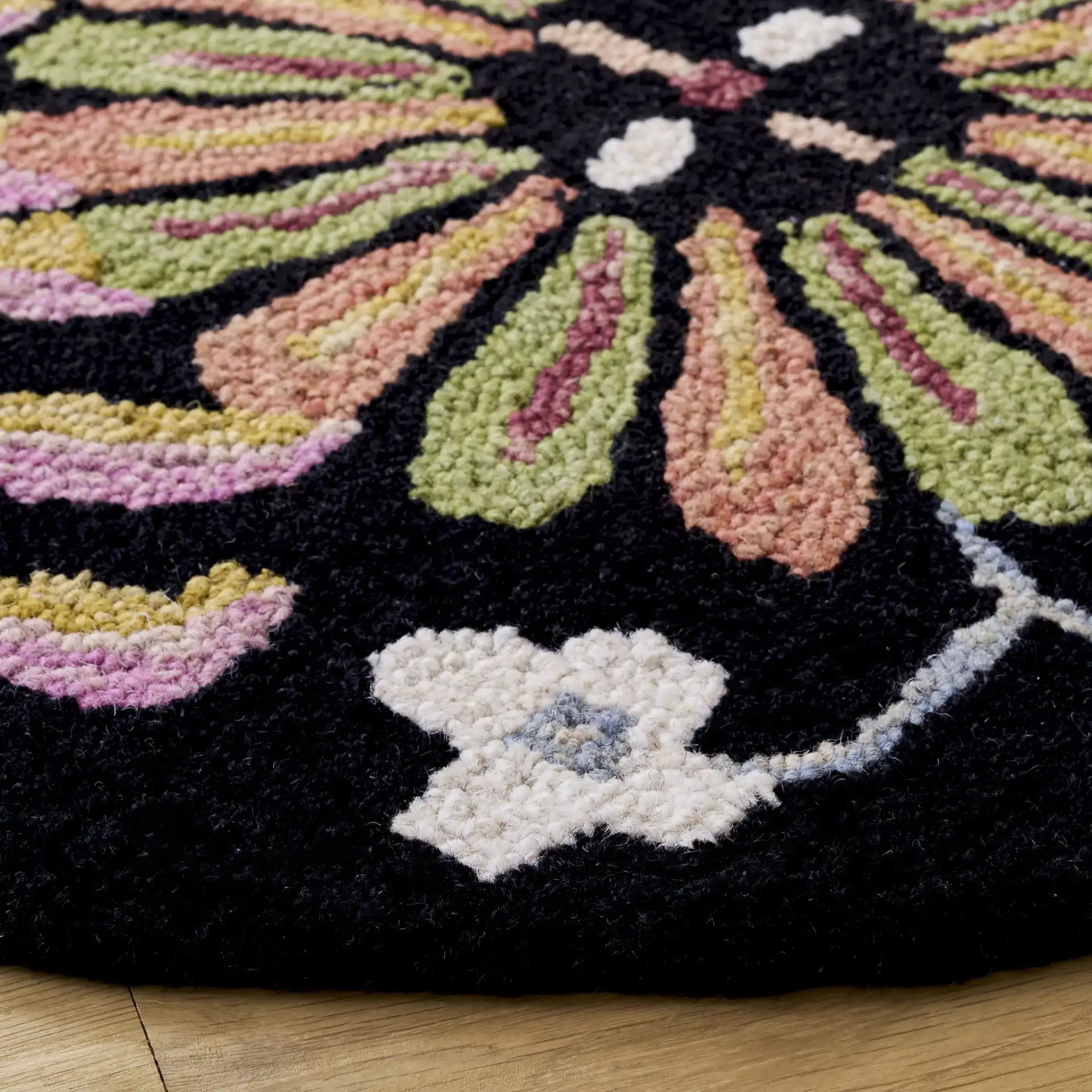 Jardin Boho Floral Hand-Tufted Wool Rug in Black / Pink in a styled room