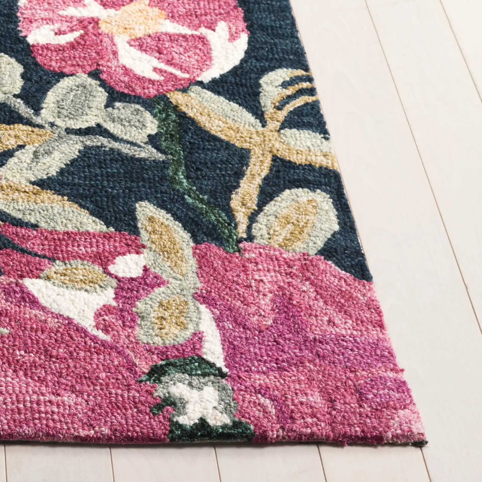 Jardin Asymmetrical Floral Hand-Tufted Wool Rug in Navy / Pink in a styled room