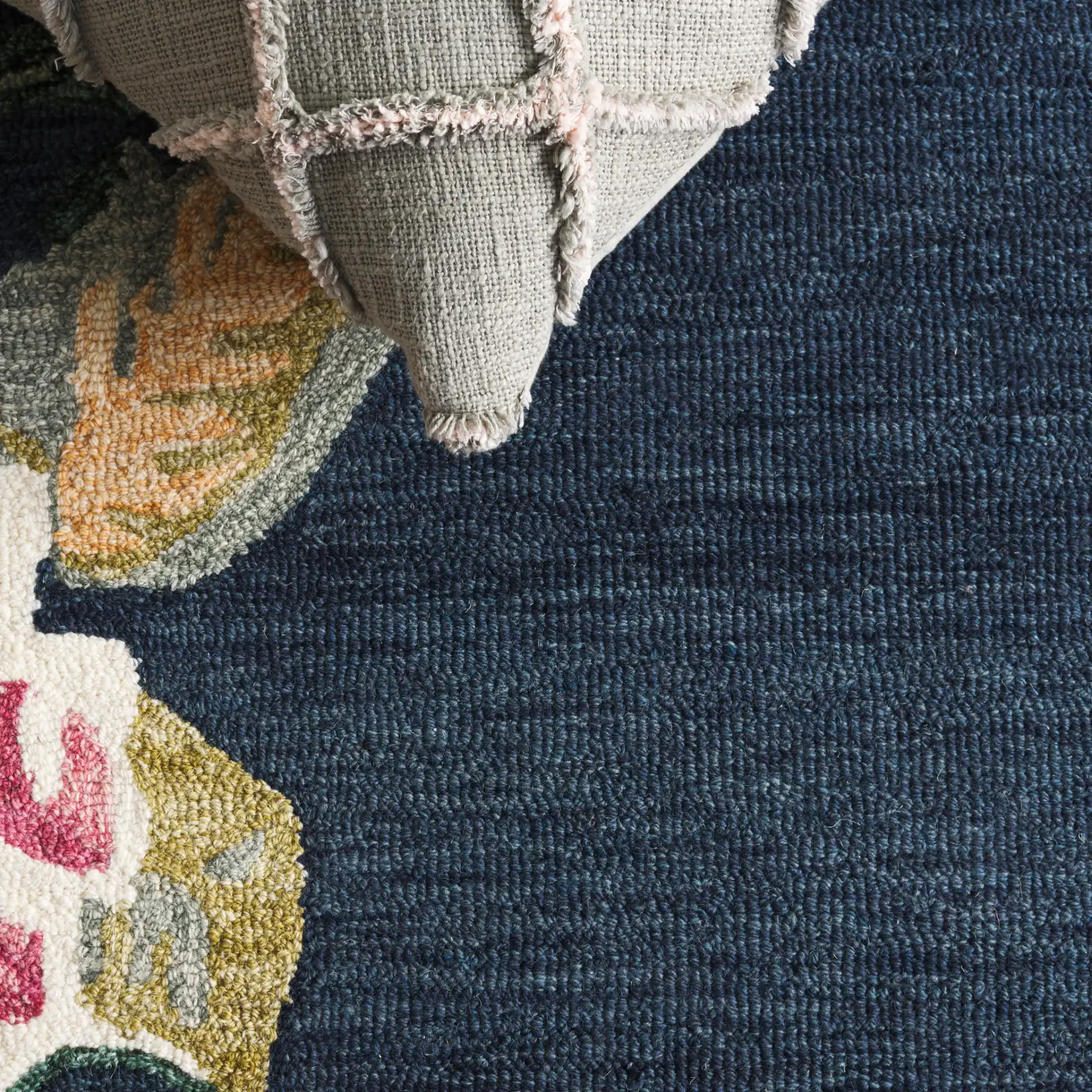 Jardin Asymmetrical Floral Hand-Tufted Wool Rug in Navy / Pink in a styled room