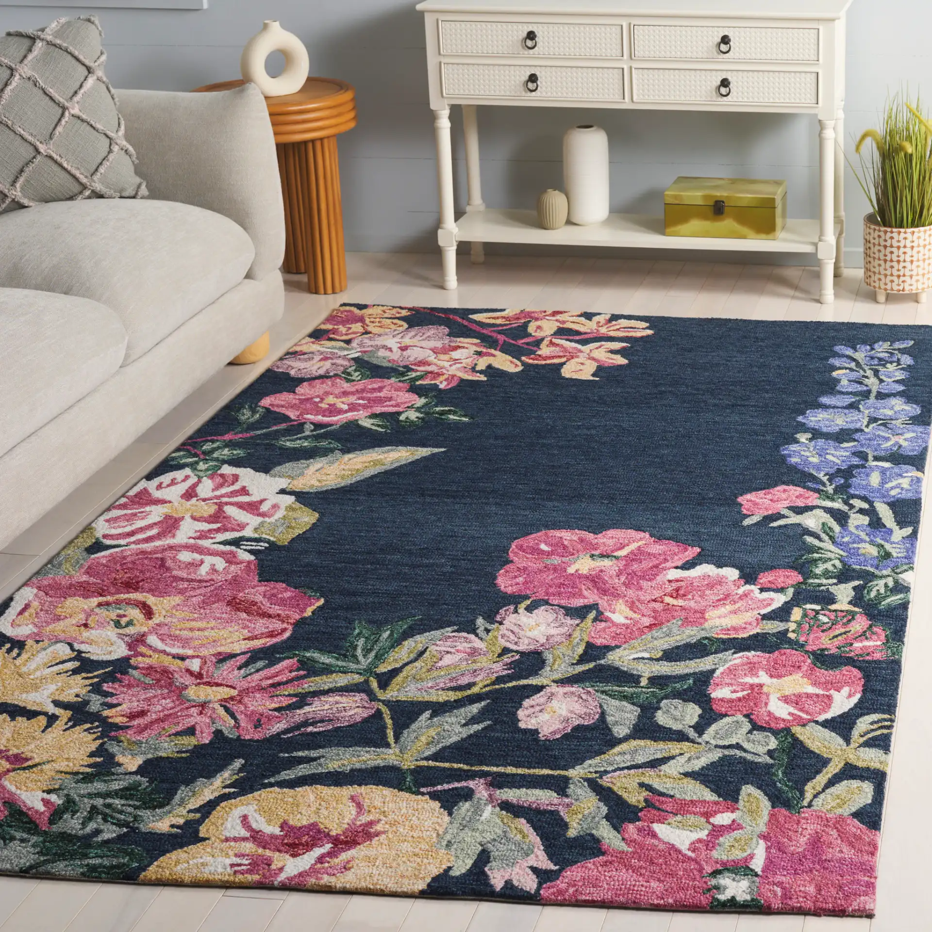 Jardin Asymmetrical Floral Hand-Tufted Wool Rug in Navy / Pink in a styled room