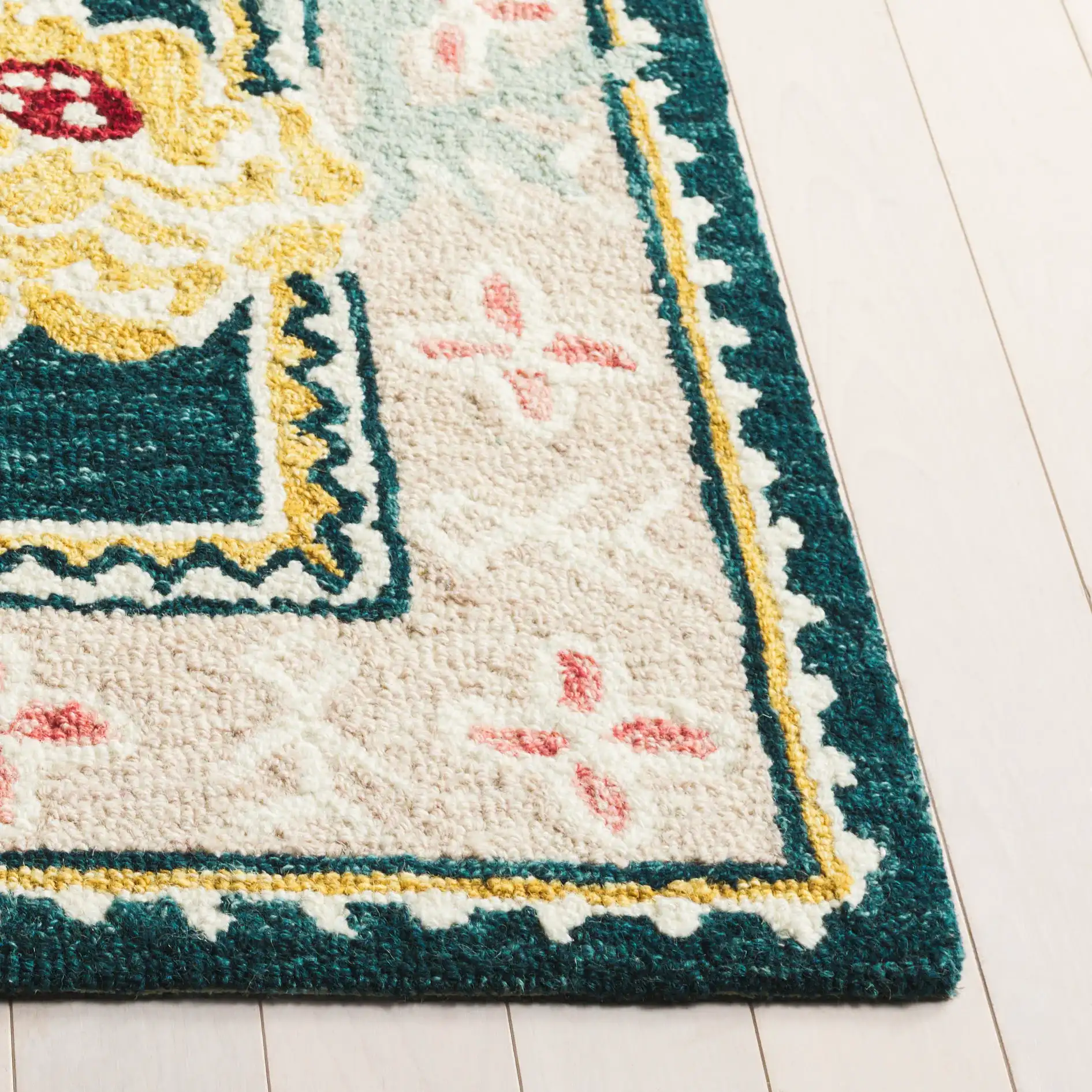 Jardin Floral Border Hand-Tufted Wool Rug in Dark Green / Pink in a styled room